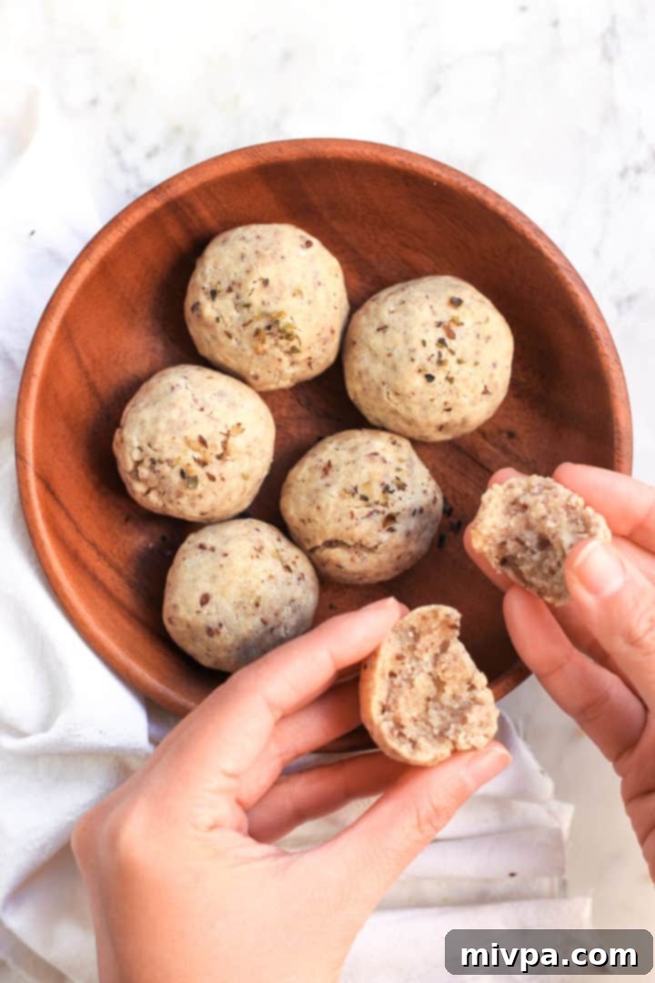 A full spread of gluten-free, egg-free, dairy-free bread rolls on a rustic wooden board, ready for a meal.