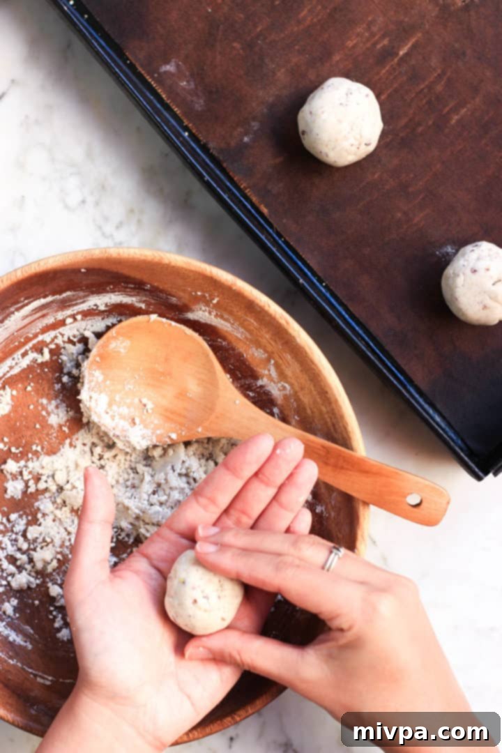 A close-up view of the interior of a freshly baked gluten-free bread roll, revealing its soft, airy texture.