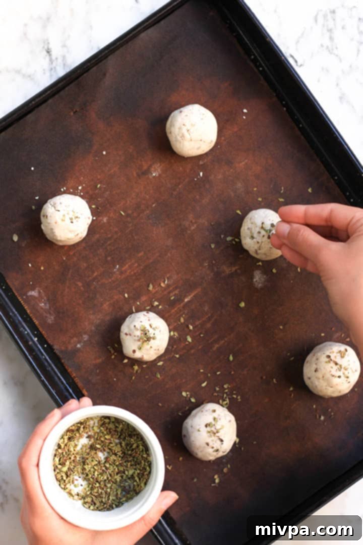 Ingredients for gluten-free bread rolls, including flaxseed meal, sorghum flour, and tapioca starch, laid out before preparation.