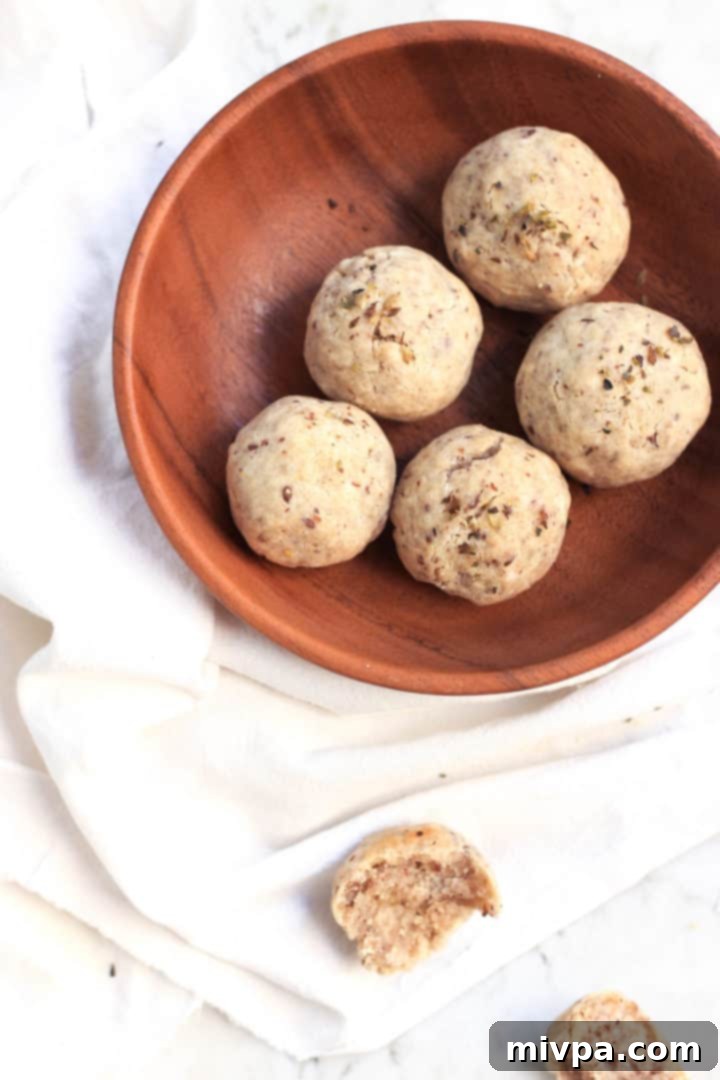 A beautifully presented gluten-free, egg-free, and dairy-free bread roll, cut open to show its inviting texture, ready to be served.