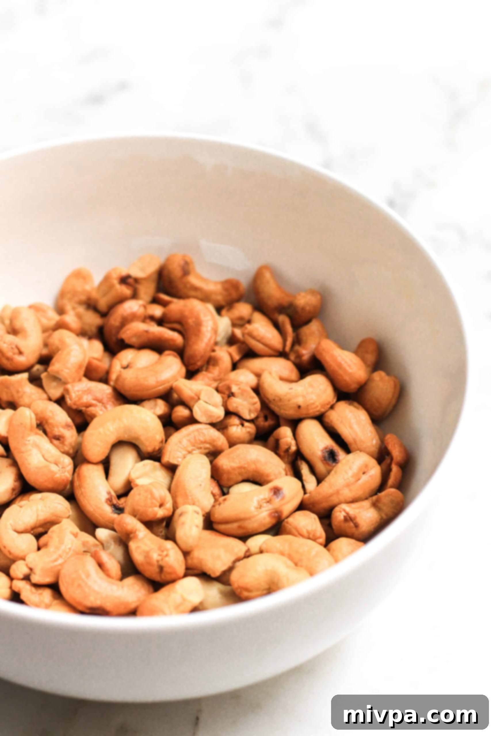Cashew Butter Cookies Recipe (Gluten-Free, Dairy-Free, Vegan) A big bowl of roasted cashew nuts.