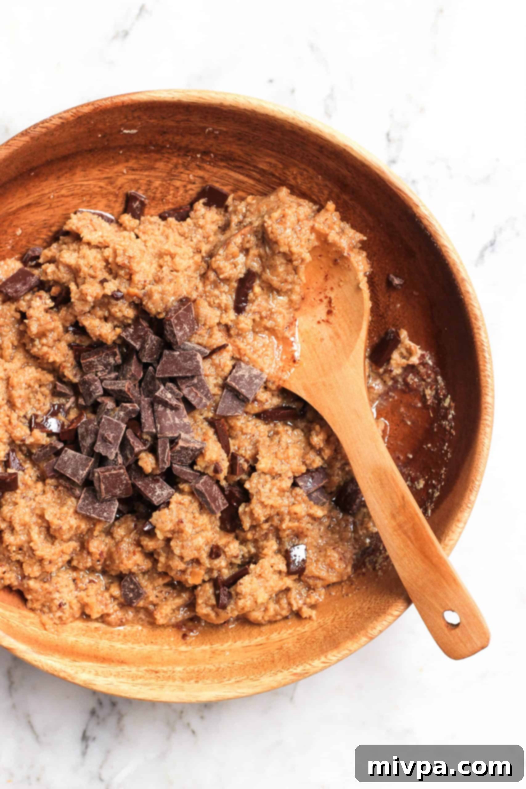 Easy Cashew Butter Cookies (Gluten-Free, Dairy-Free, Vegan) Cookie dough and chocolate chunks in a wooden bowl.