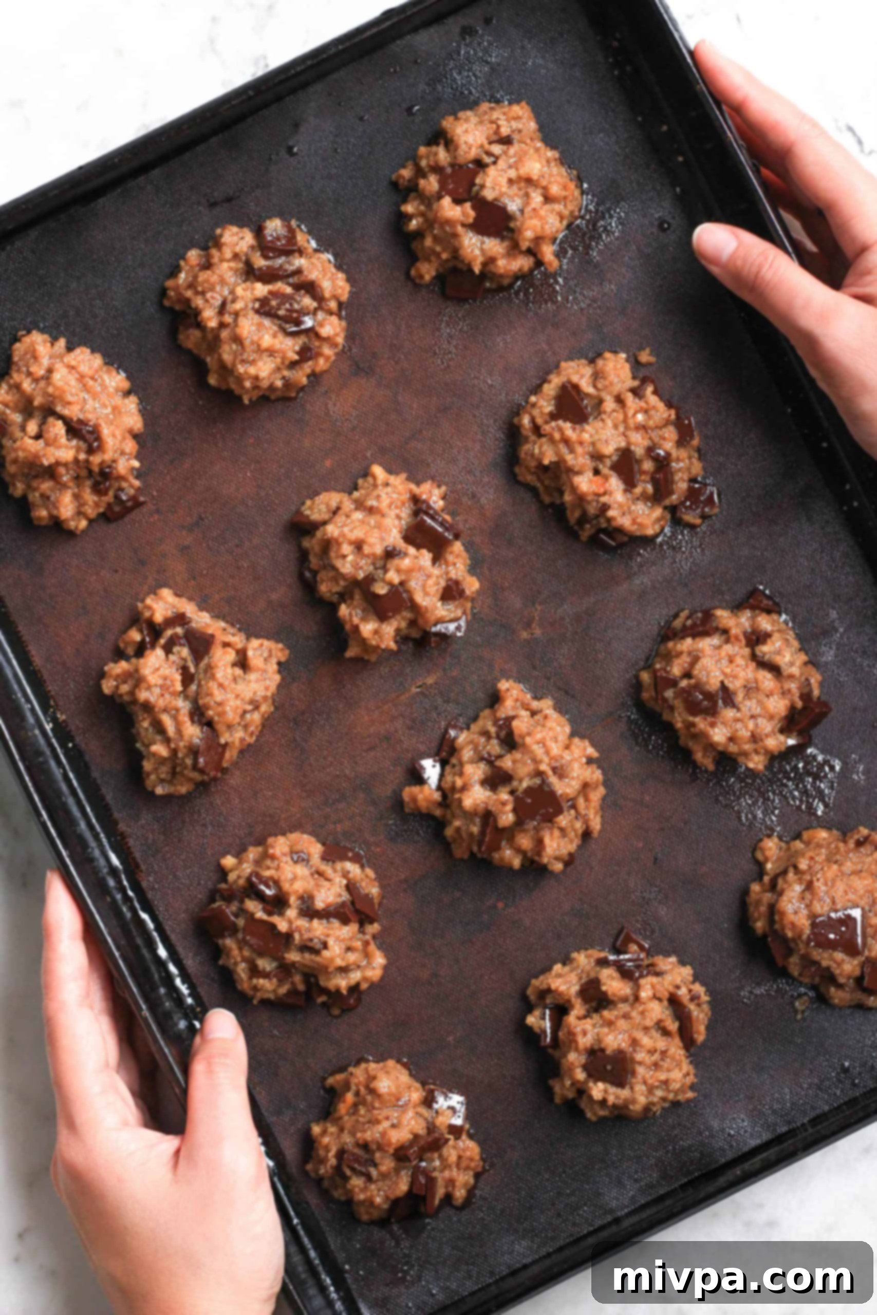 Cashew Butter Cookies Recipe (Gluten-Free, Vegan) Holding a baking sheet with cookie dough.