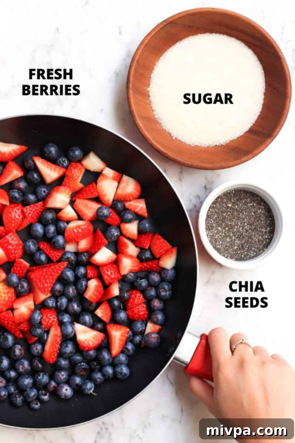 Mixed Berry Jam Recipe No Pectin (Gluten-Free, Vegan) A visual display of all ingredients required for mixed berry jam recipe: fresh strawberries, blueberries, sugar, and chia seeds.
