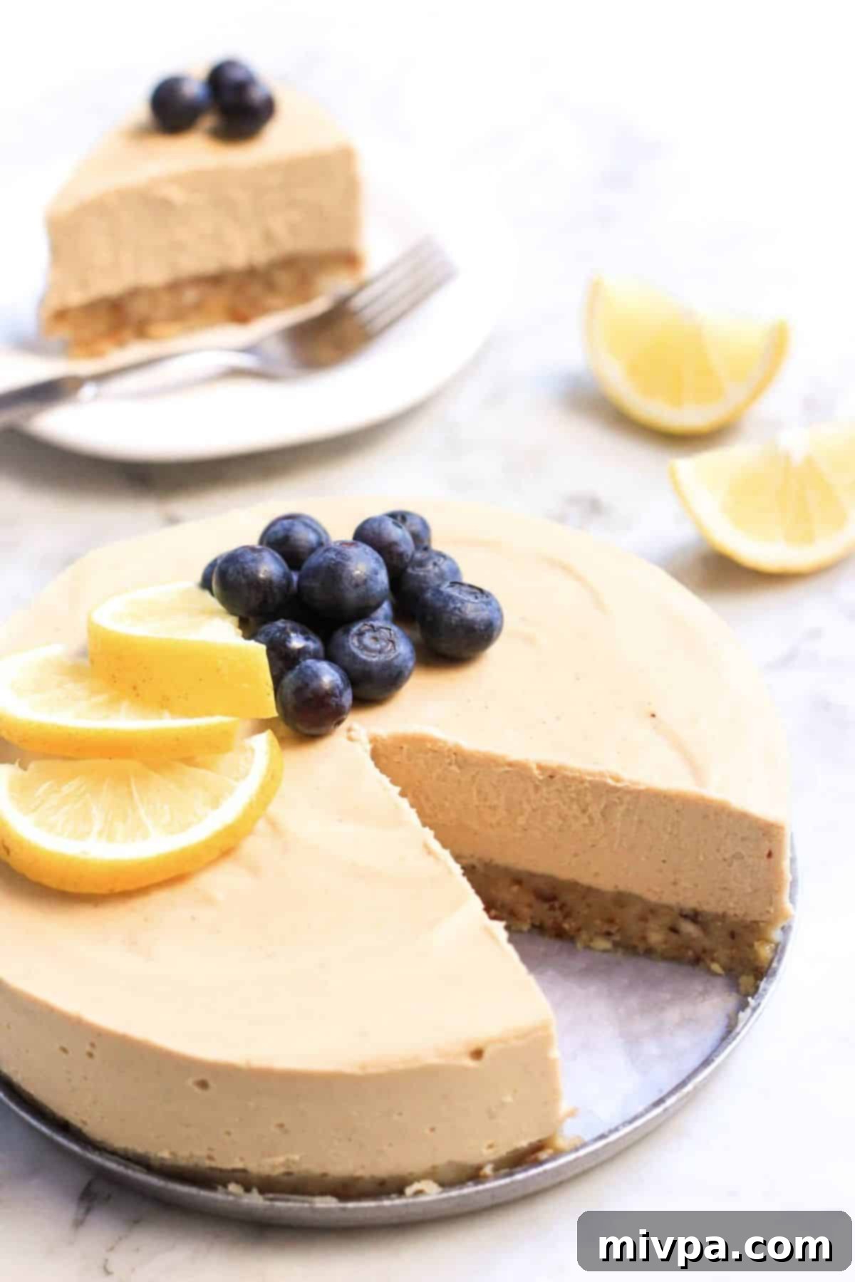 Up close shot of half-eaten vegan lemon cheesecake.
