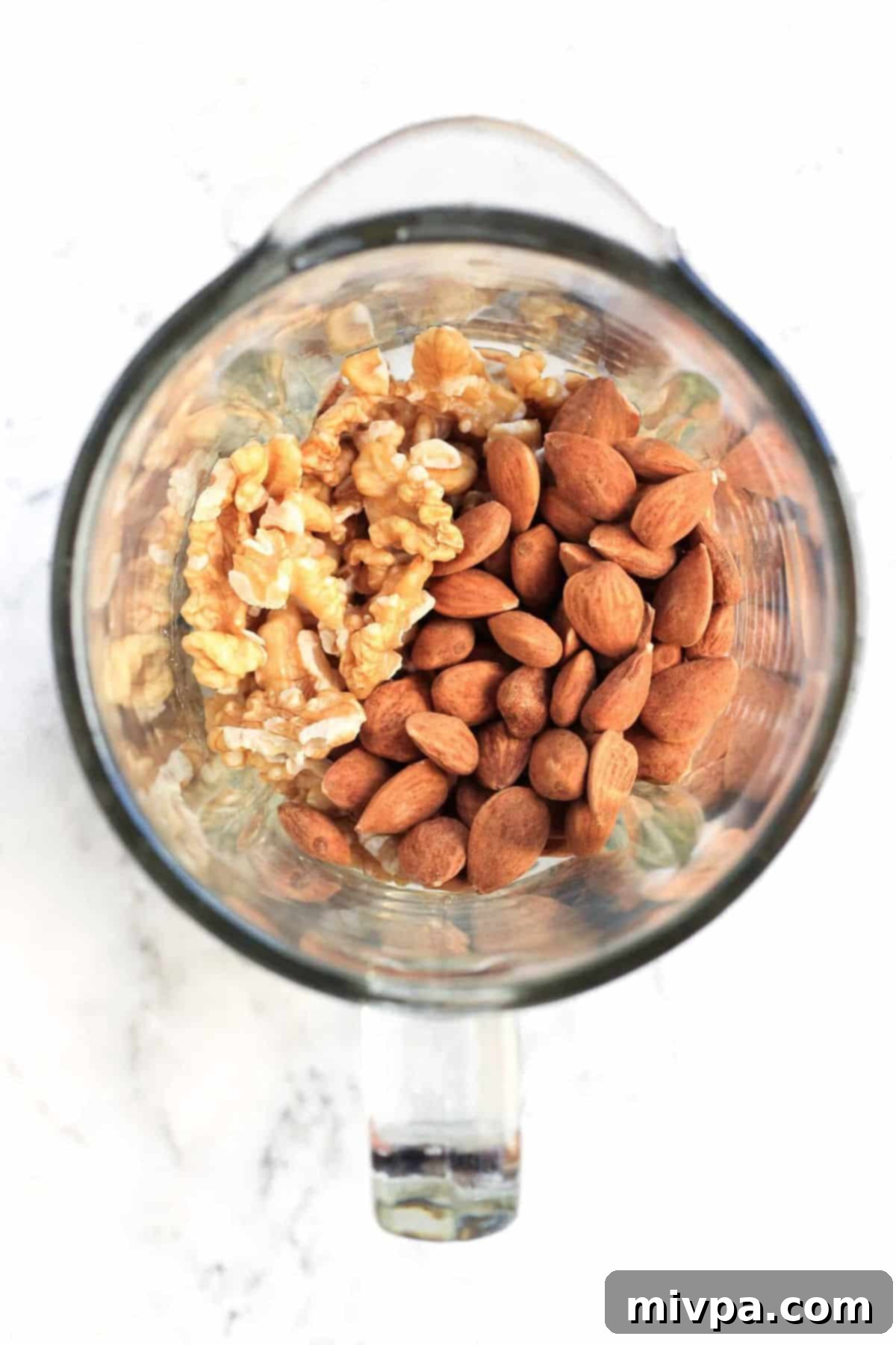 Top down view of nuts in high-speed blender.
