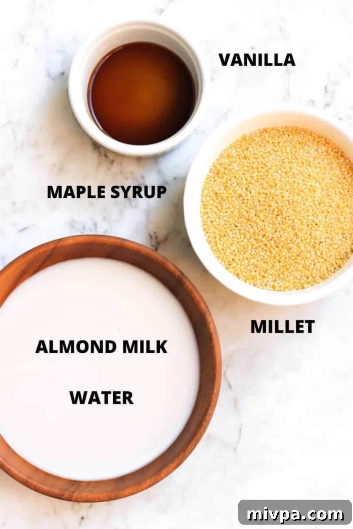 Ingredients for millet breakfast porridge recipe laid out on marble board.