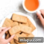 Plant Based Gluten Free Sorghum Graham Crackers 16 Hand reaching for sorghum graham crackers on plate
