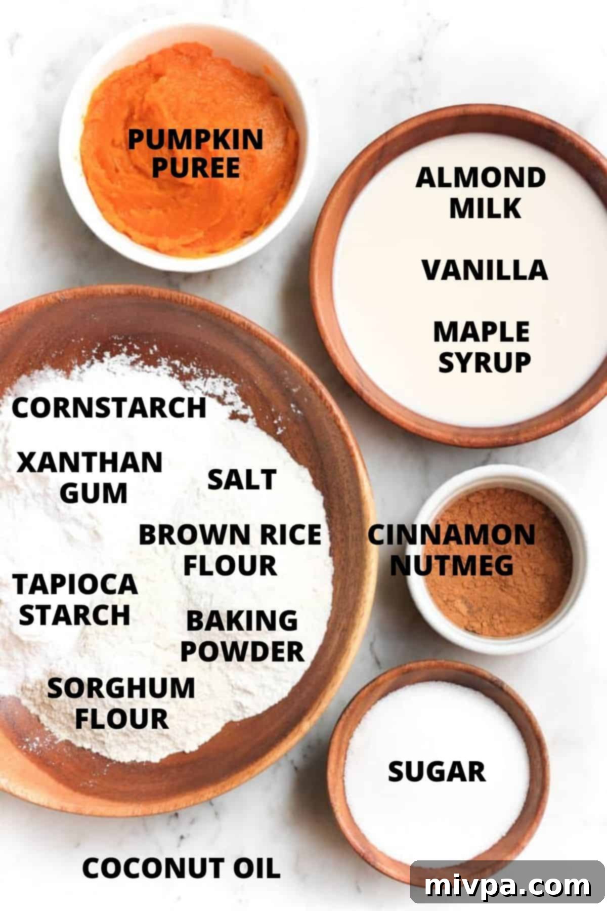 All essential ingredients for the gluten-free dairy-free pumpkin muffins recipe, neatly arranged on a rustic marble board.