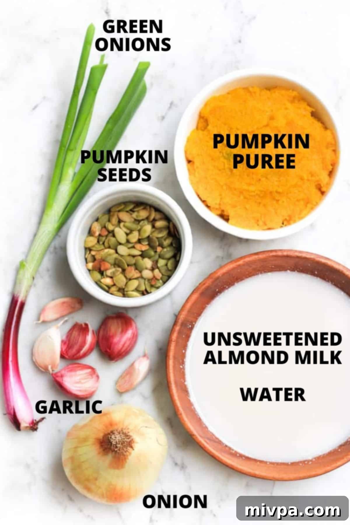 Vegan Pumpkin Soup Recipe (Gluten-free) Ingredients for vegan pumpkin soup recipe laid out on a marble board.
