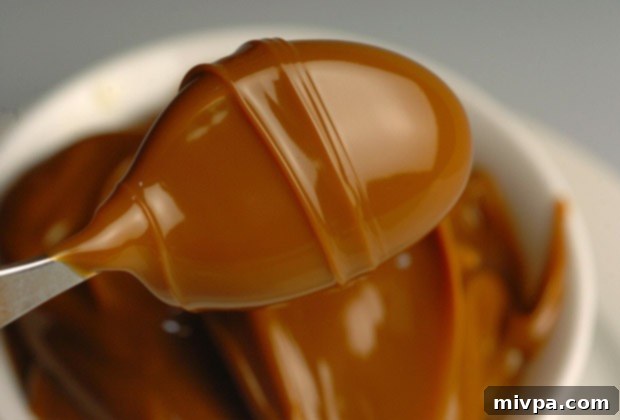 A jar of rich, dark caramel Dulce de Leche, a quintessential Argentine delicacy.