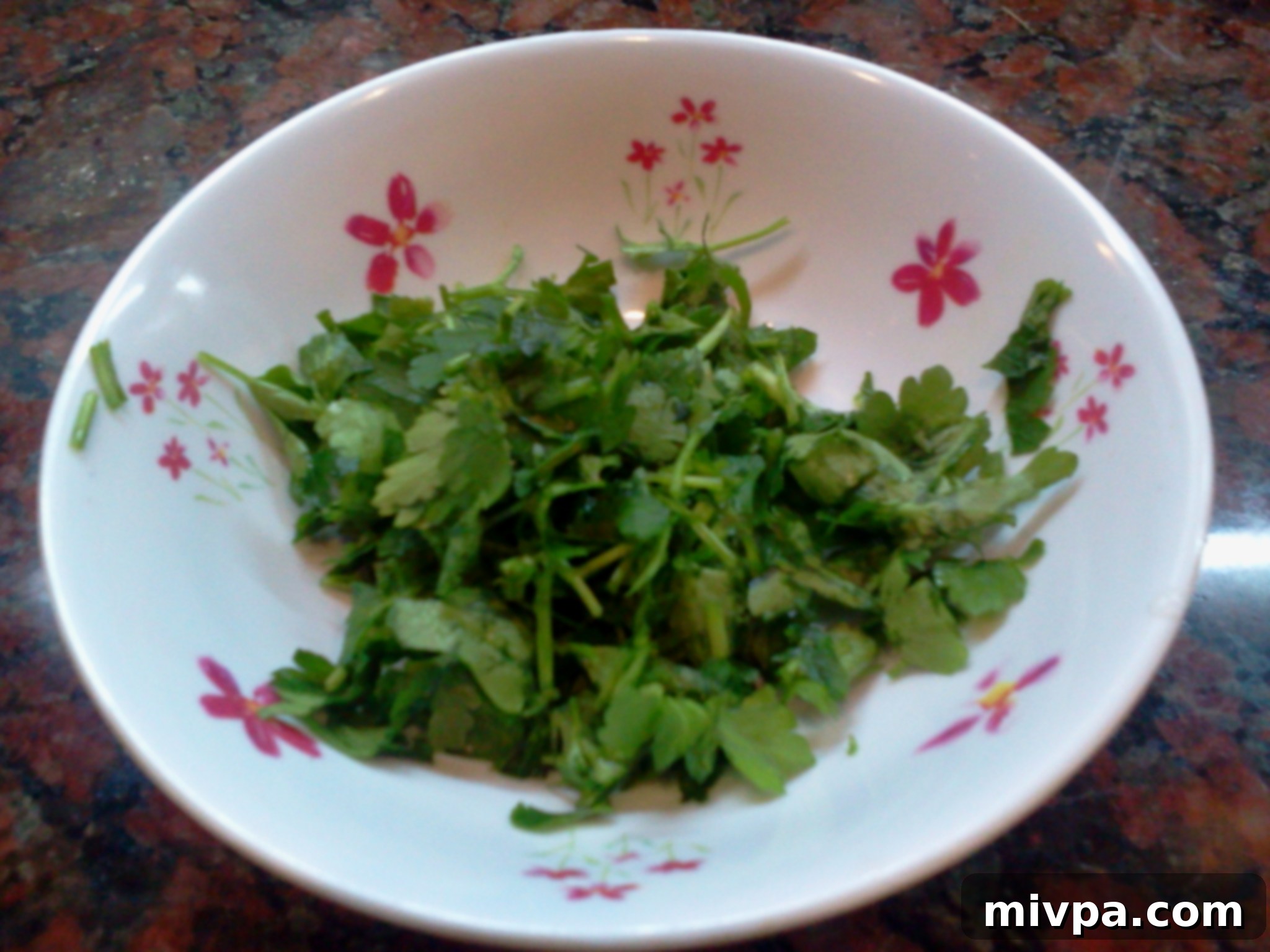 Finely chopped fresh parsley, ready to be used as a garnish.