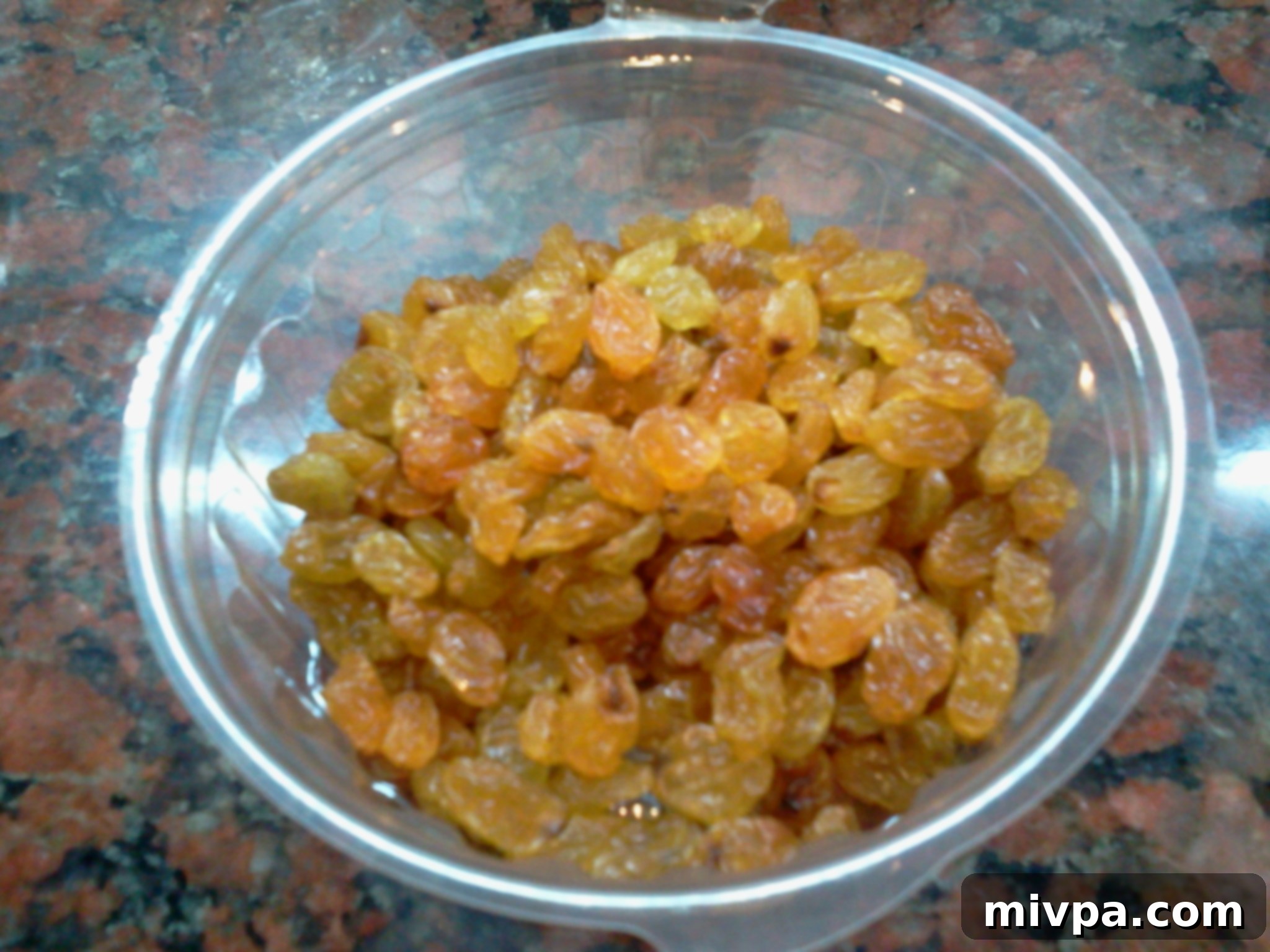 A small packet of golden raisins, ready to be added to the cooked pilaf.