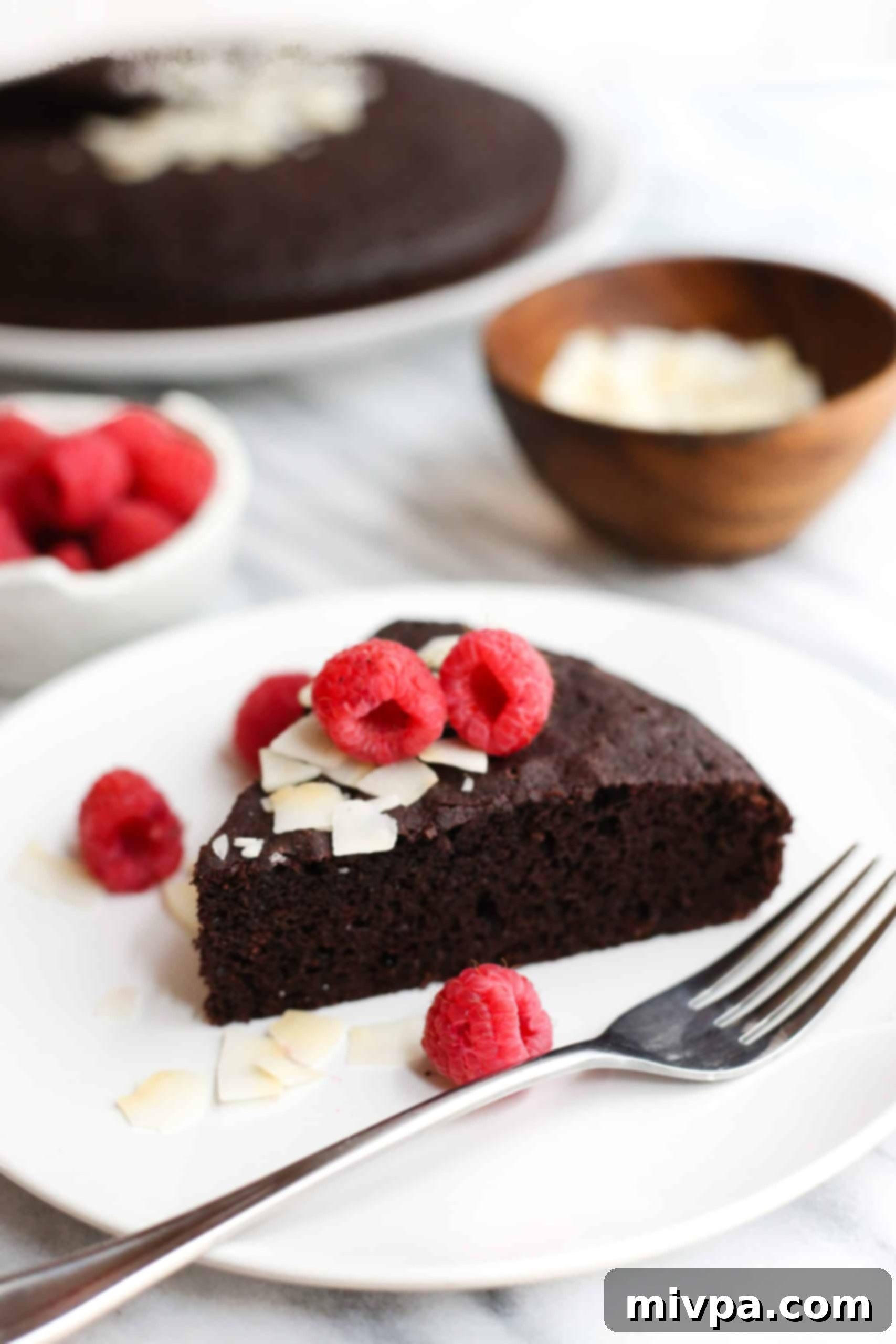 Coconut Flour Chocolate Cake (Gluten-Free, Dairy-Free) A slice of coconut flour chocolate cake and a fork on a small plate.