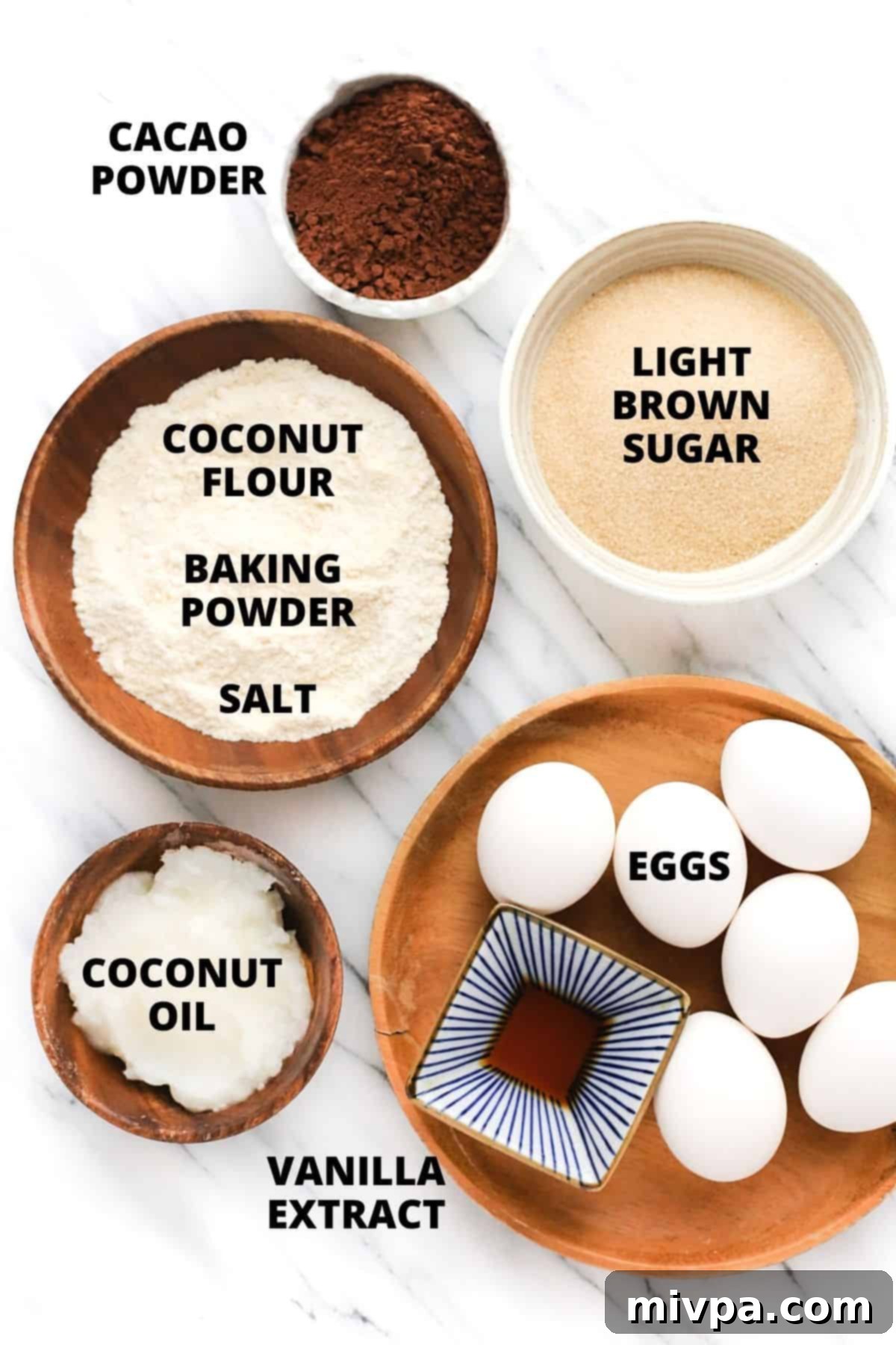 Coconut Flour Chocolate Cake (Gluten-Free, Dairy-Free) Labeled ingredients for coconut flour chocolate cake recipe set out on a marble board.