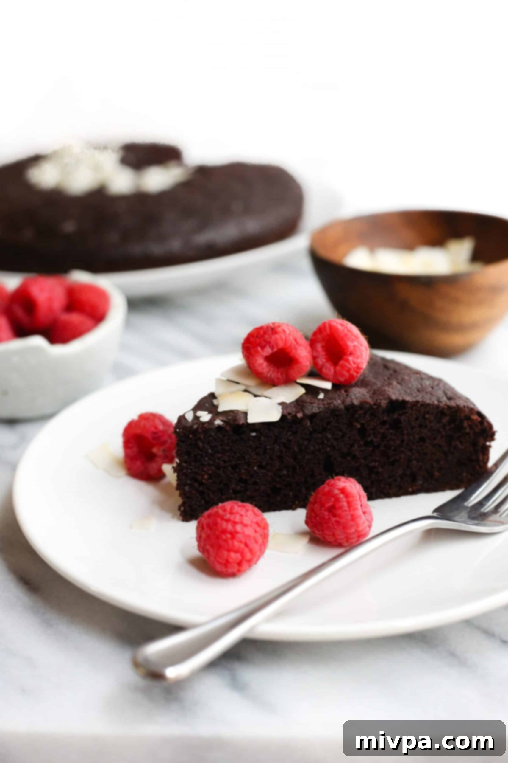 Flourless Chocolate Cake (Gluten-Free, Dairy-Free) A slice of gluten-free chocolate cake on a small serving plate.