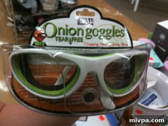 A person wearing protective goggles while cutting onions, demonstrating a barrier method.