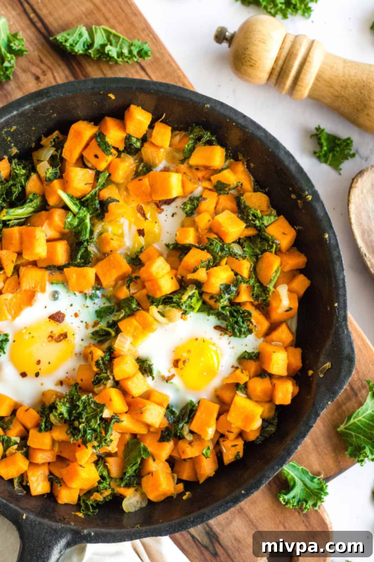Finished Sweet Potato & Kale Breakfast Skillet, topped with black pepper and chili flakes.