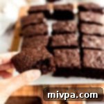 A freshly baked gluten-free dairy-free brownie, showcasing a beautiful crinkly top and rich chocolate color.