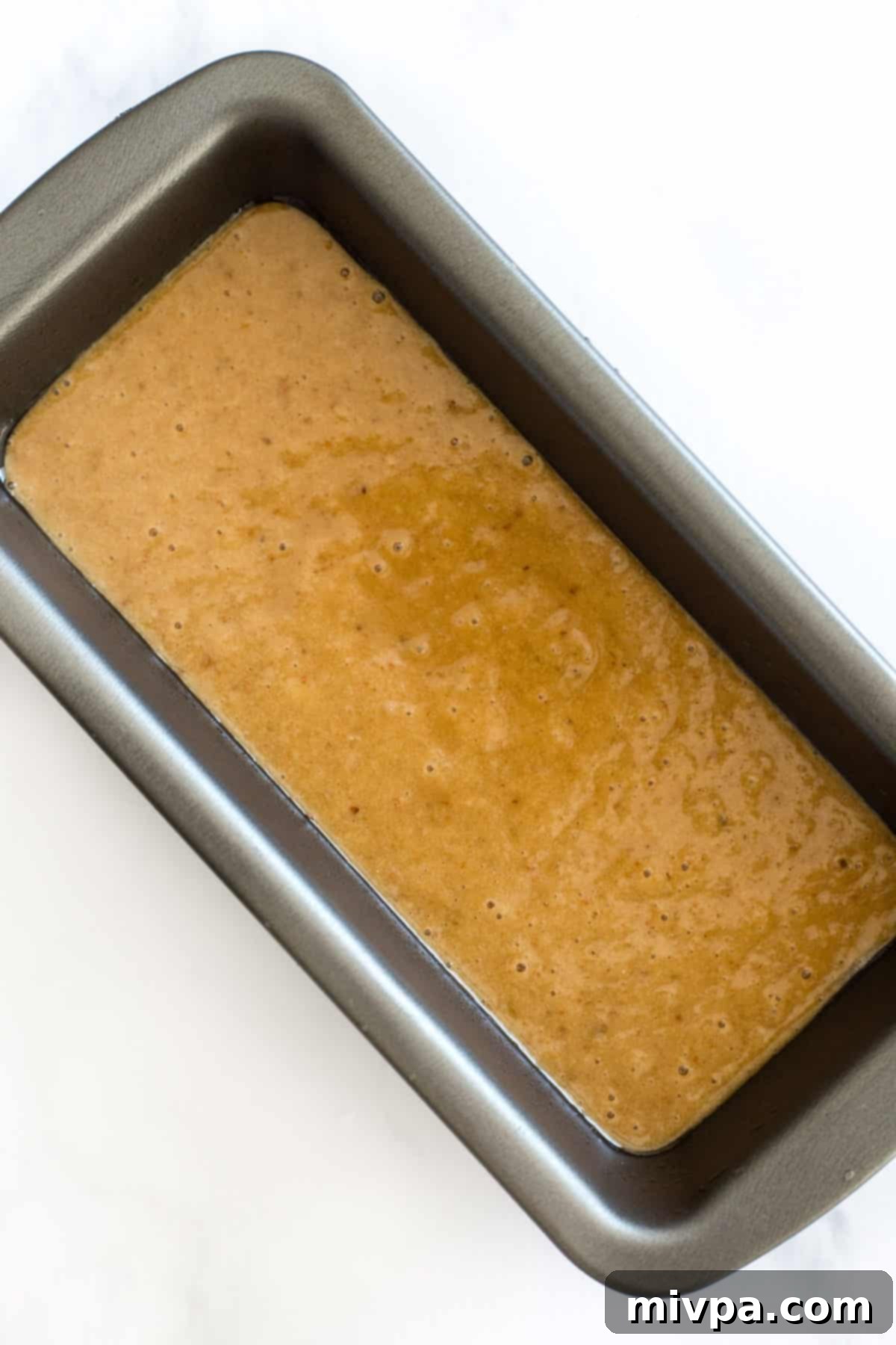 Banana bread batter in loaf pan