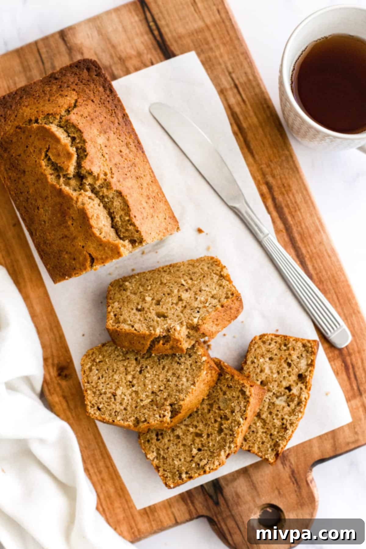 A half-sliced loaf of dairy-free banana bread.