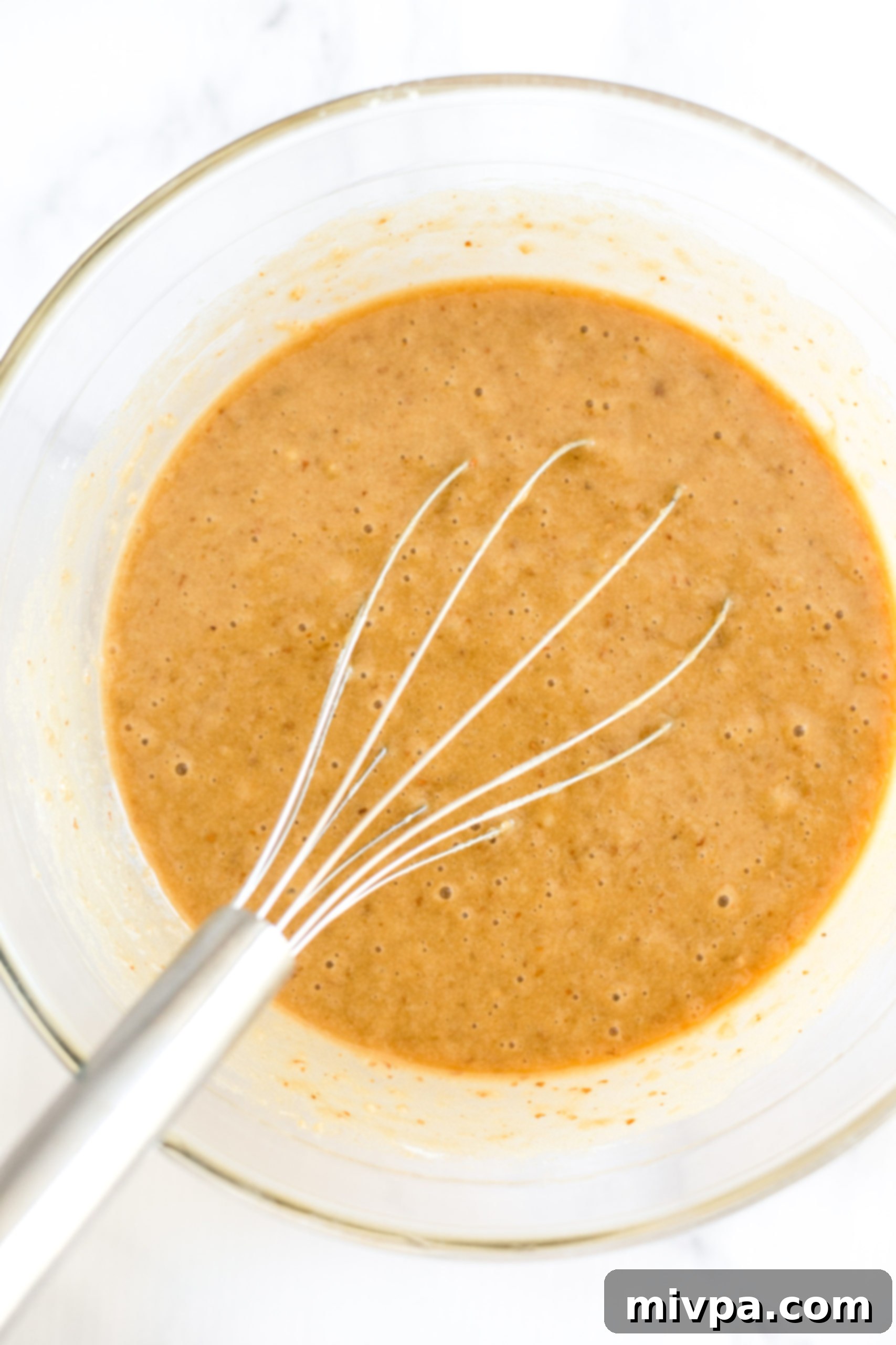 Gluten-free banana bread batter in a large bowl.
