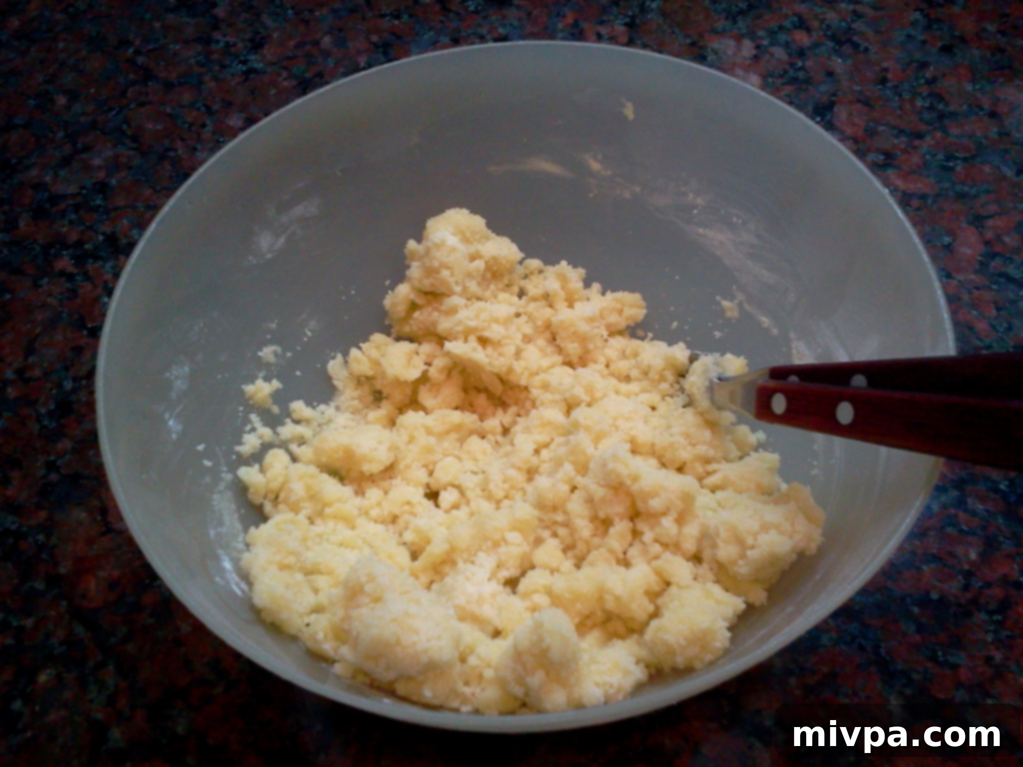 The cookie dough mixture after being thoroughly combined, resulting in a smooth and uniform consistency, ready for kneading.