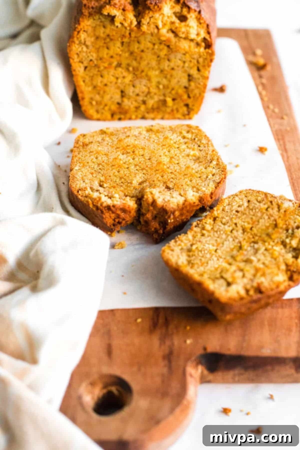 Sliced pieces of carrot loaf on parchment.