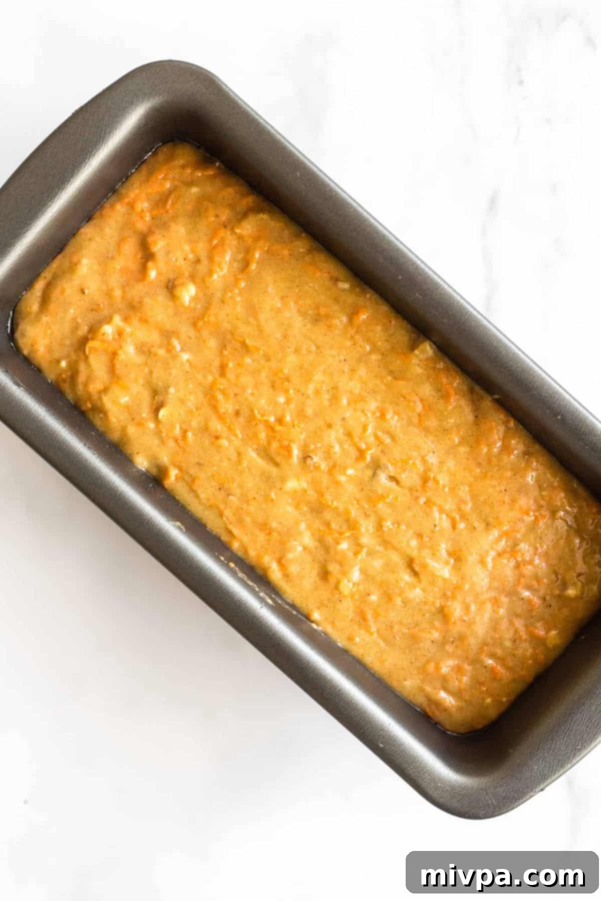Carrot cake bread batter in loaf pan.