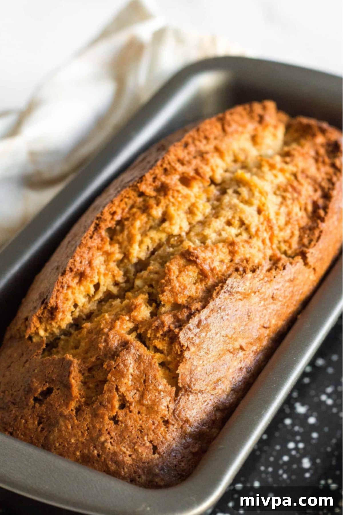 Freshly baked loaf of healthy carrot bread in metal pan