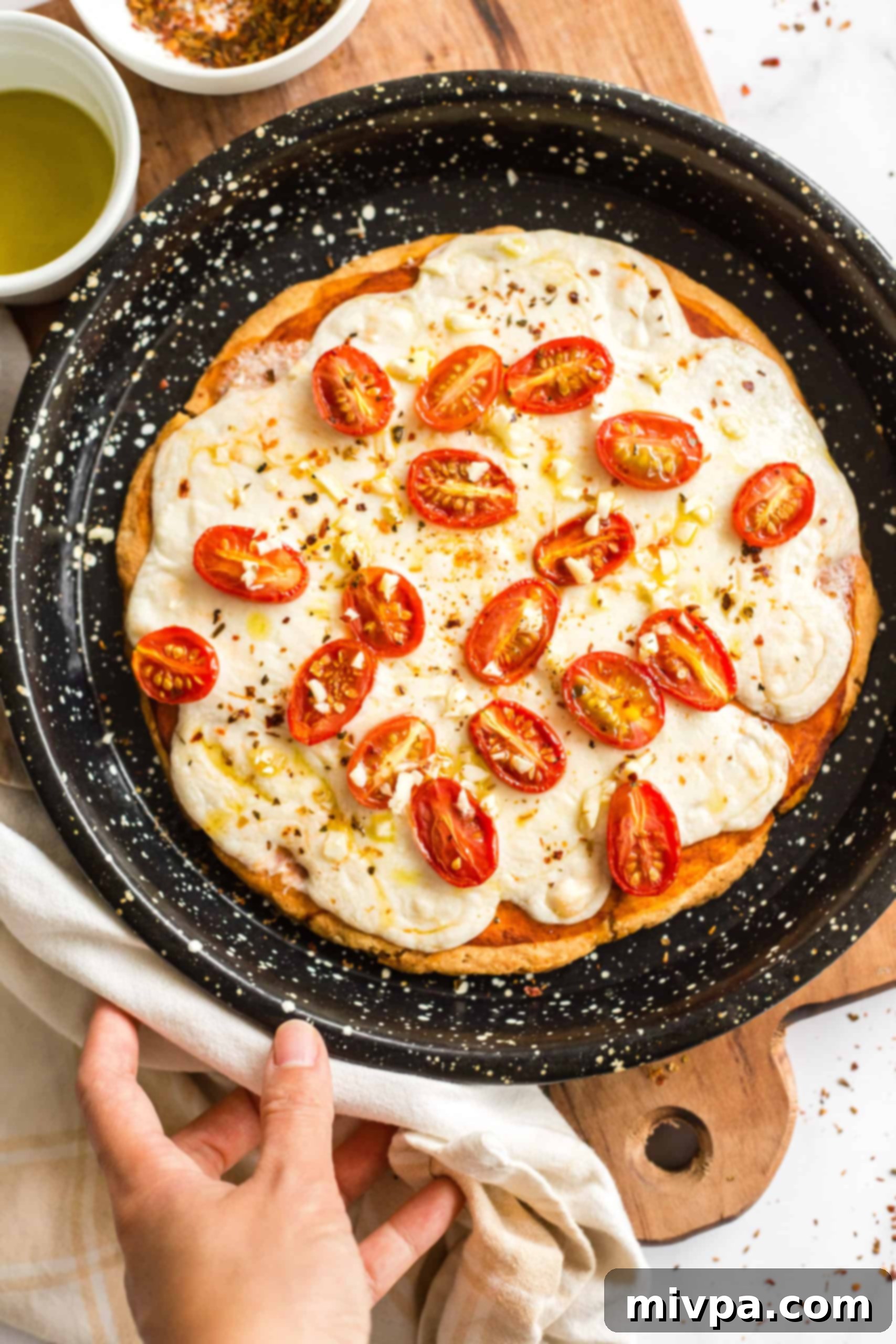 Gluten-free pizza in a pizza pan.