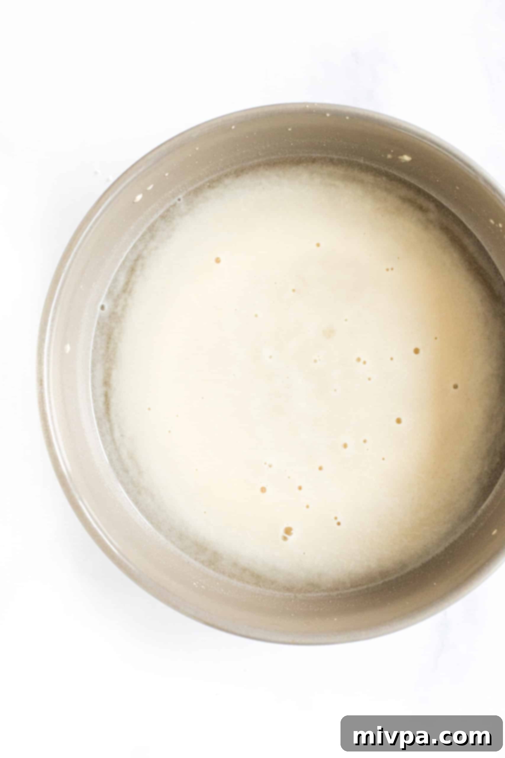 The Best Gluten-Free Focaccia Bread (Dairy-Free, Vegan) A bowl of yeast mixture foaming up.