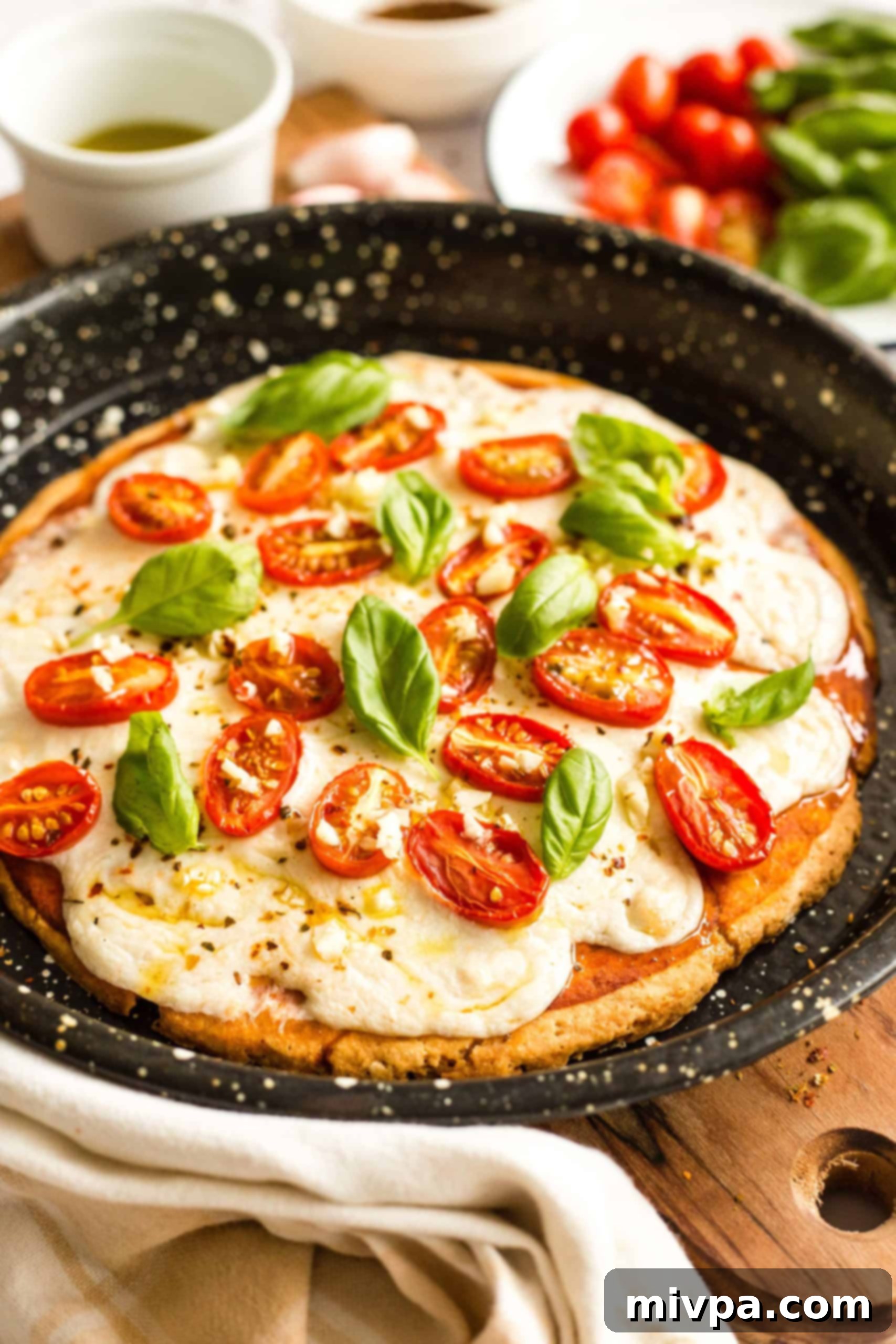 Easy Caprese Pizza (Gluten-Free, Vegan) Freshly baked gluten-free caprese pizza on a pizza pan.