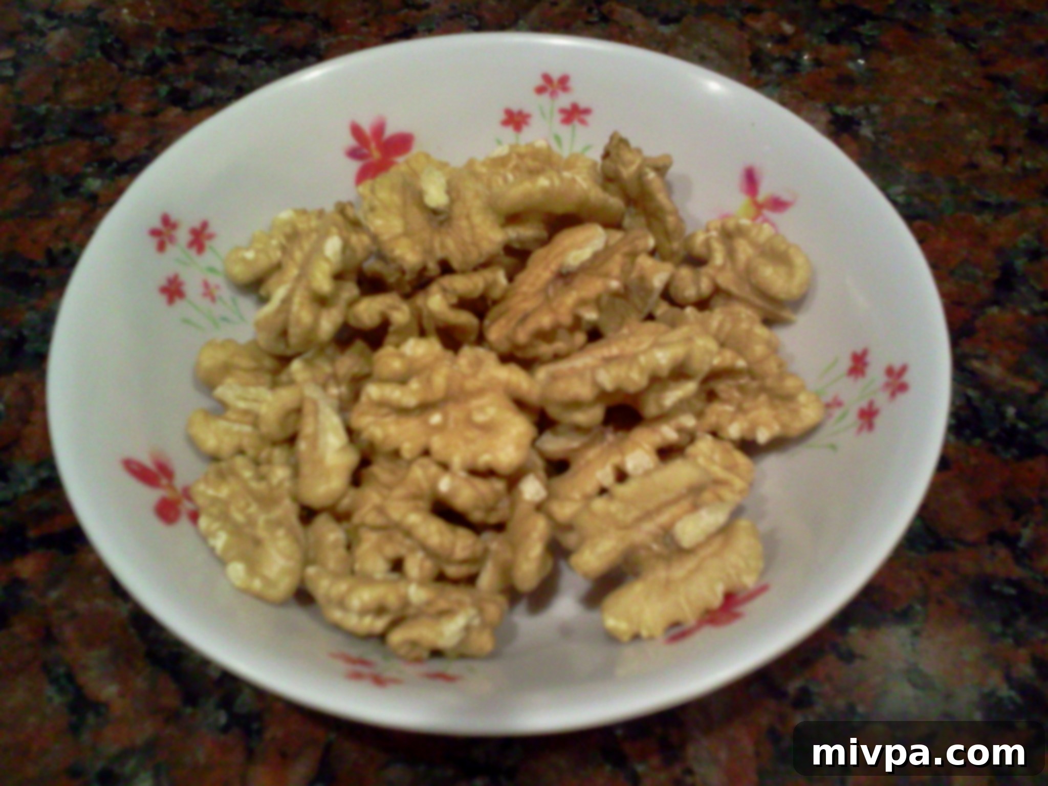 Fresh, whole walnuts in their shells, ready to be prepared for baking.