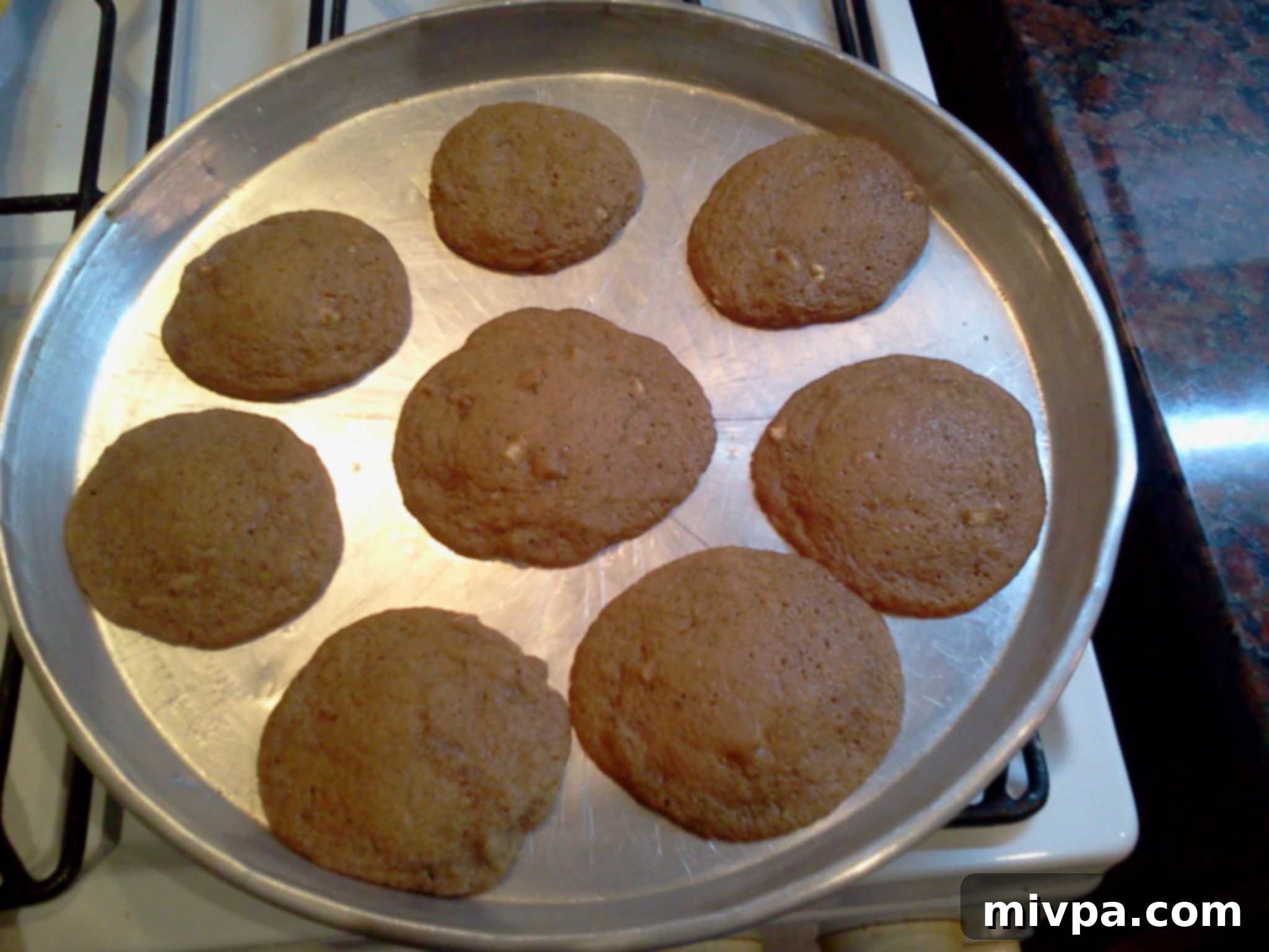 A batch of freshly baked coffee walnut fudge cookies, golden brown and warm, just out of the oven.