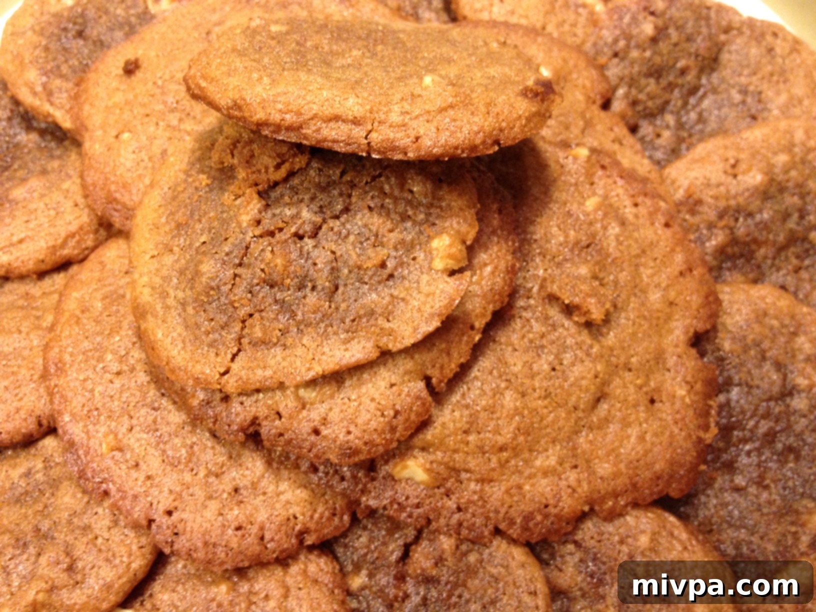 A close-up shot of the finished coffee walnut fudge cookies, showcasing their chewy texture and fudge center.