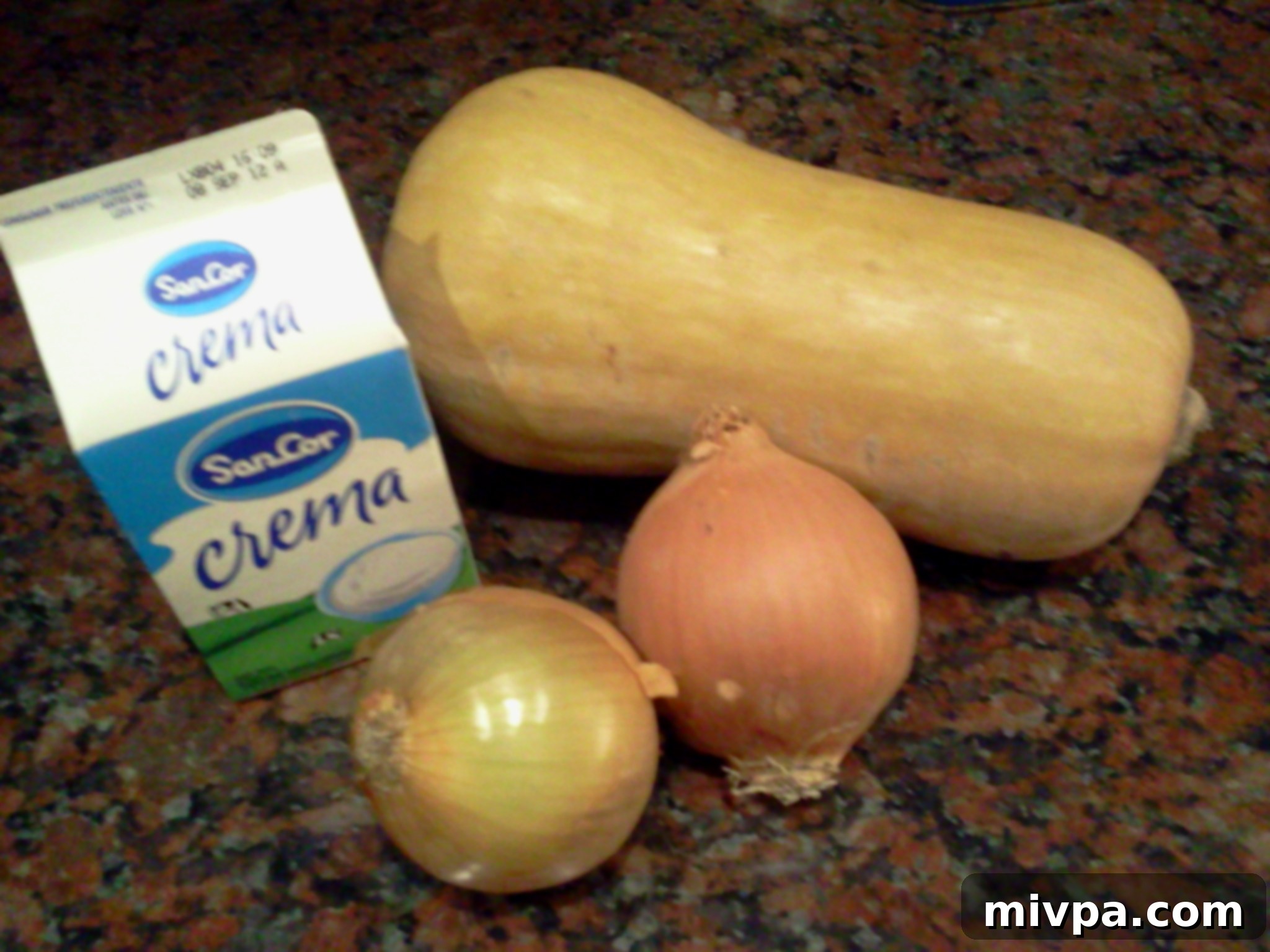 Fresh ingredients for Butternut Squash Tower recipe including whole butternut squash and onions