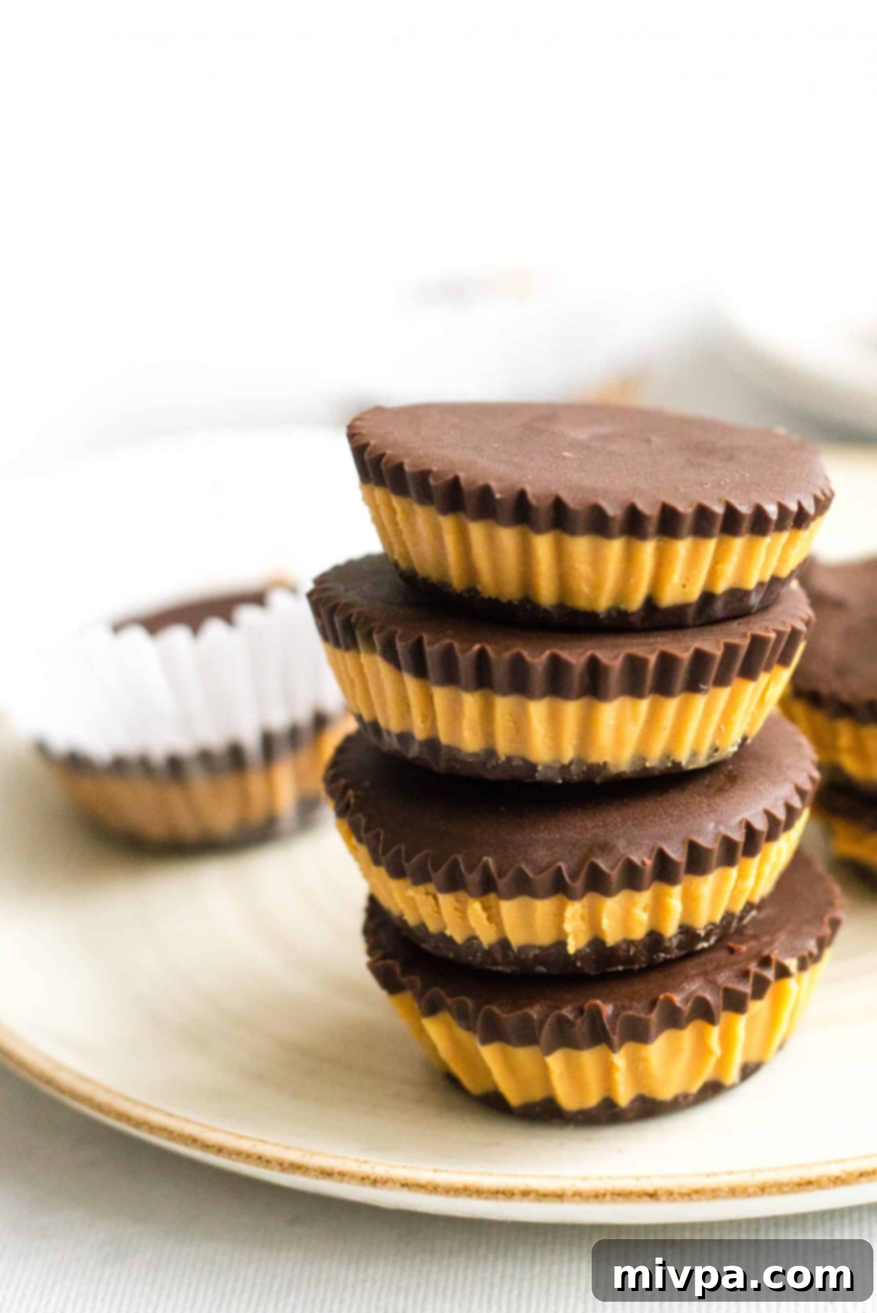 Healthy Peanut Butter Cups (Gluten-Free, Vegan) Gluten-free peanut butter cups stacked on a plate.