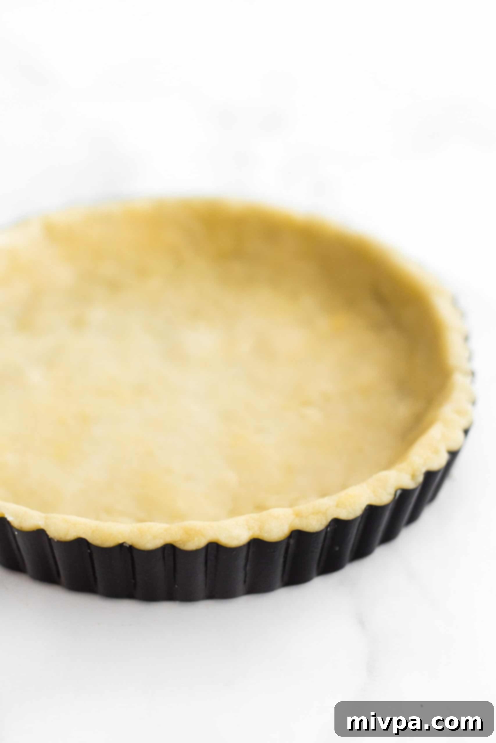 Dairy-Free Gluten-Free Pecan Pie Close up picture of pie crust dough in pie tin.