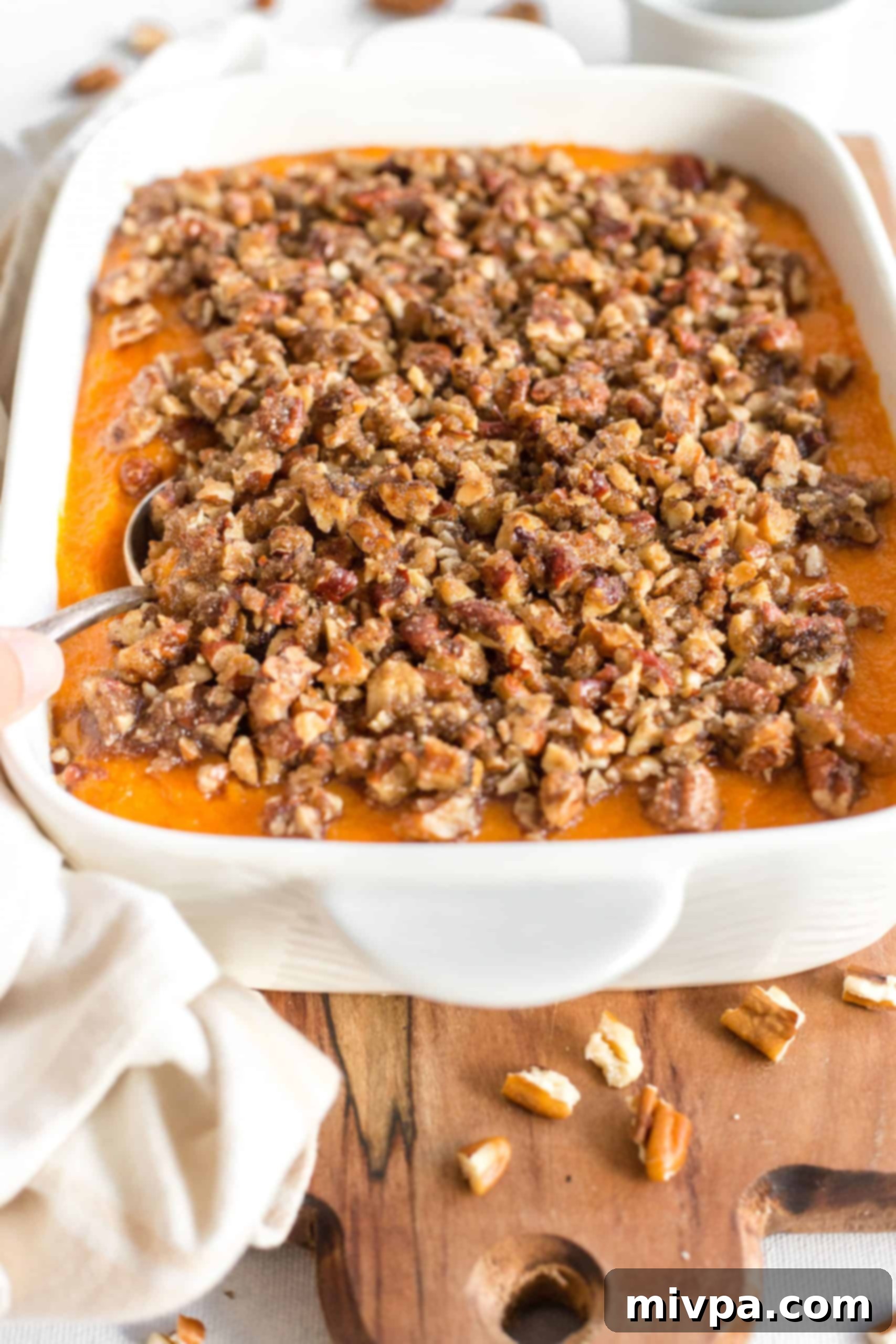 Gluten-Free Sweet Potato Casserole (Dairy-Free) Sweet potato casserole on a wooden board, ready to be served.