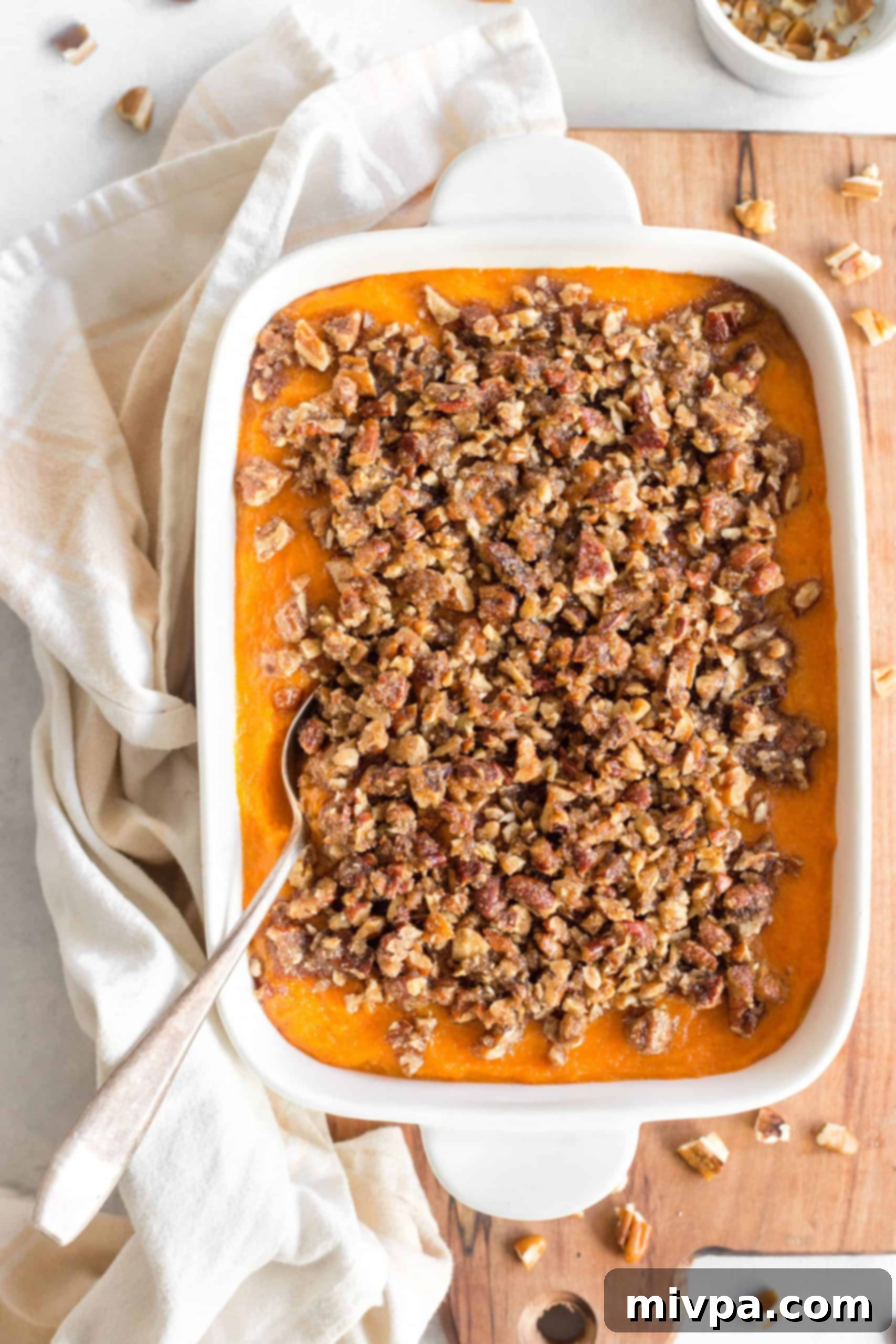 Gluten Dairy-Free Sweet Potato Casserole Top down view of a gluten-free sweet potato casserole on a wooden board.