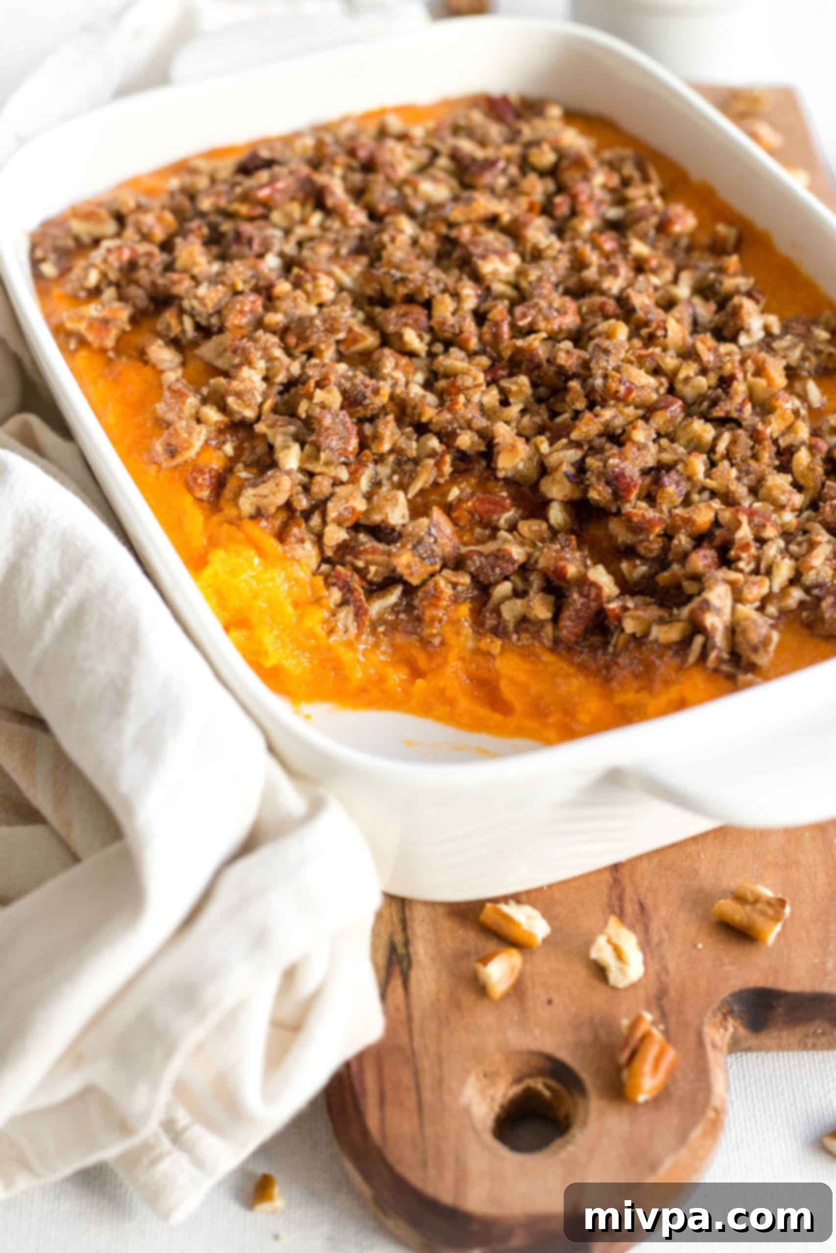 Gluten-Free Sweet Potatoes Casserole (Dairy-Free) Gluten-free sweet potato casserole on a wooden board.