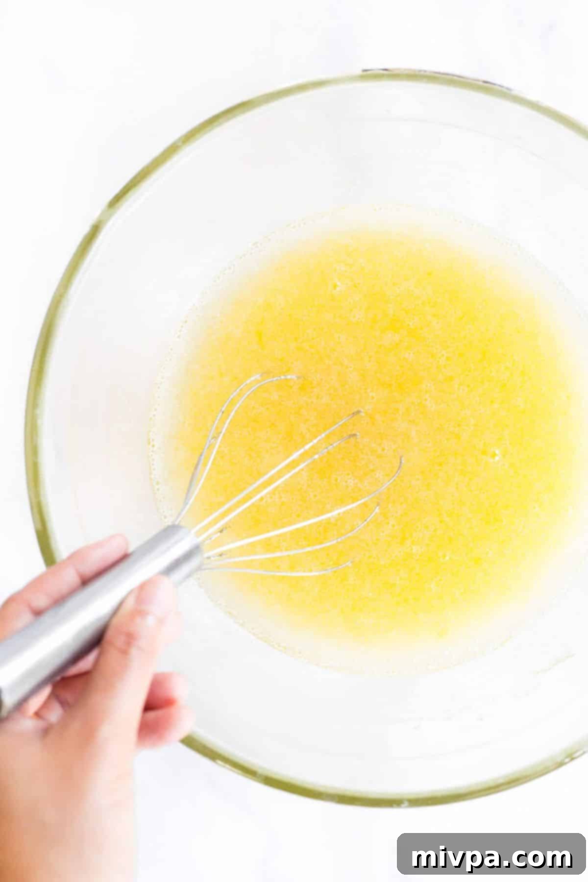 Whisk egg mixture in glass bowl