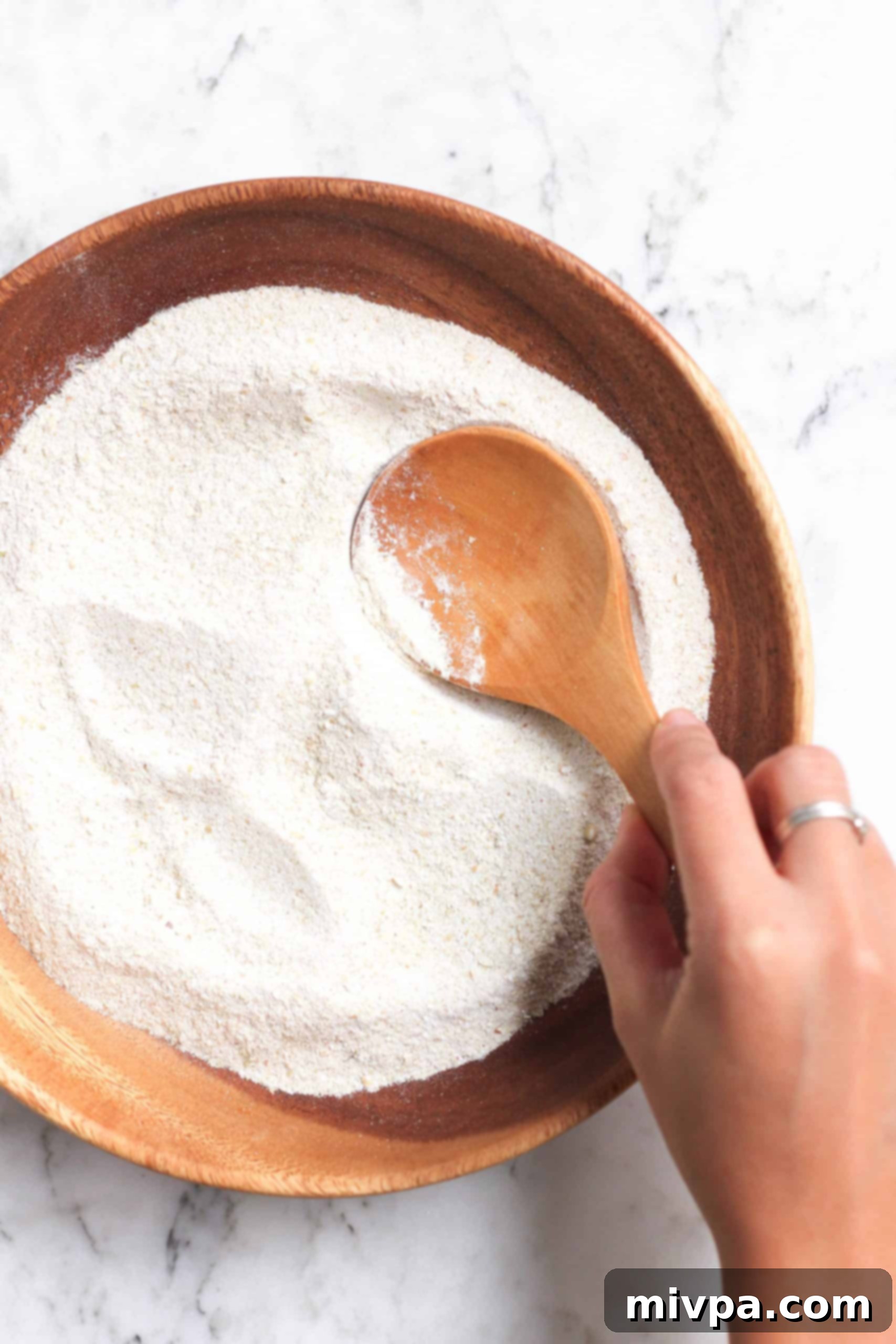 How to Make Buckwheat Flour (Gluten-Free, Vegan) Mixing a bowl of homemade buckwheat flour