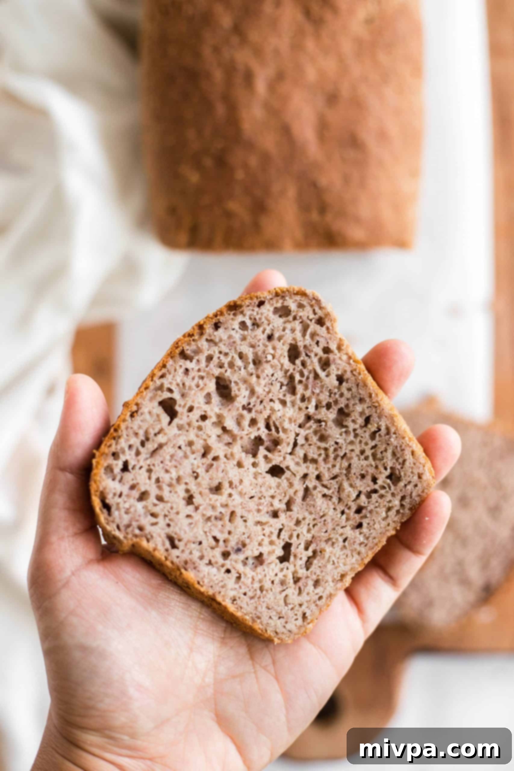 Holding up a slice of buckwheat bread.
