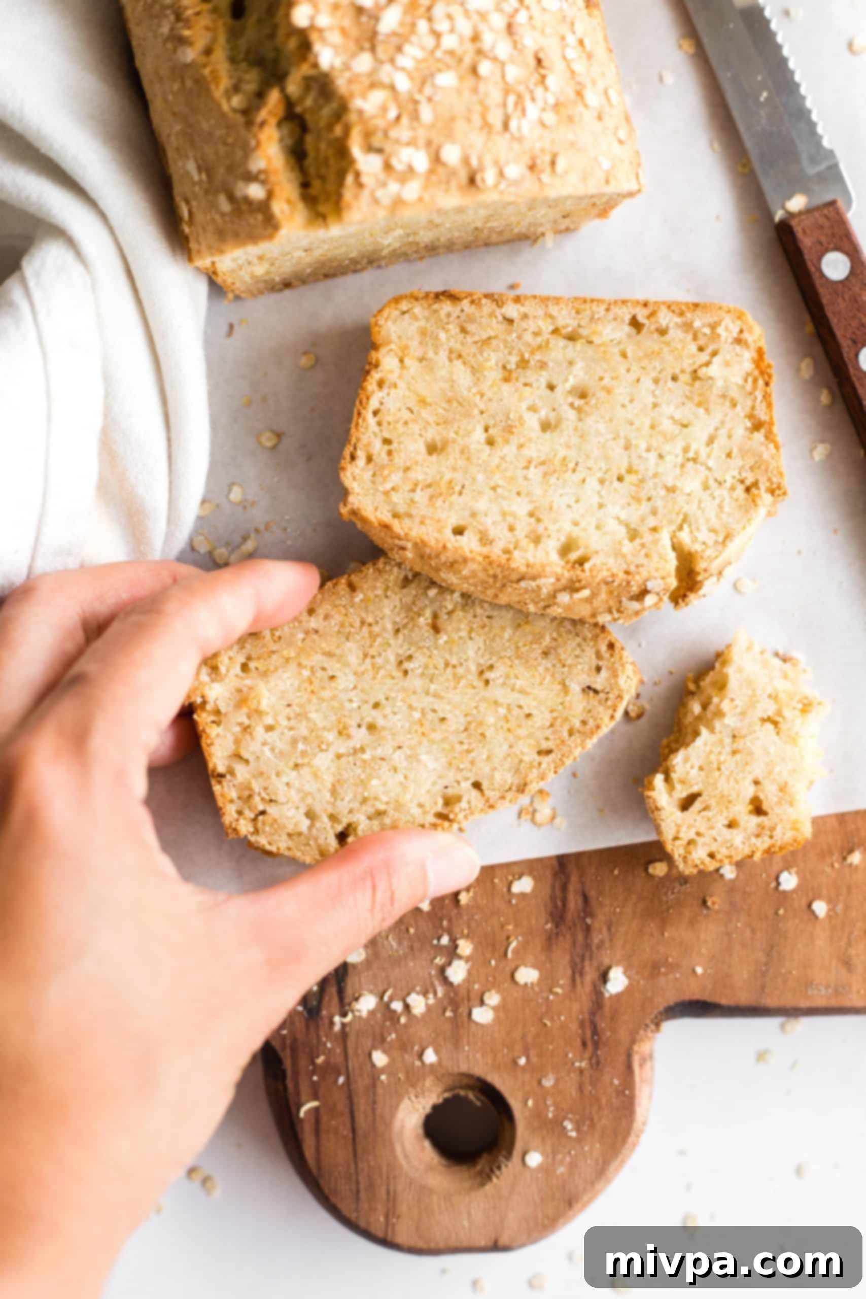 Hand reaching for a slice of bread.