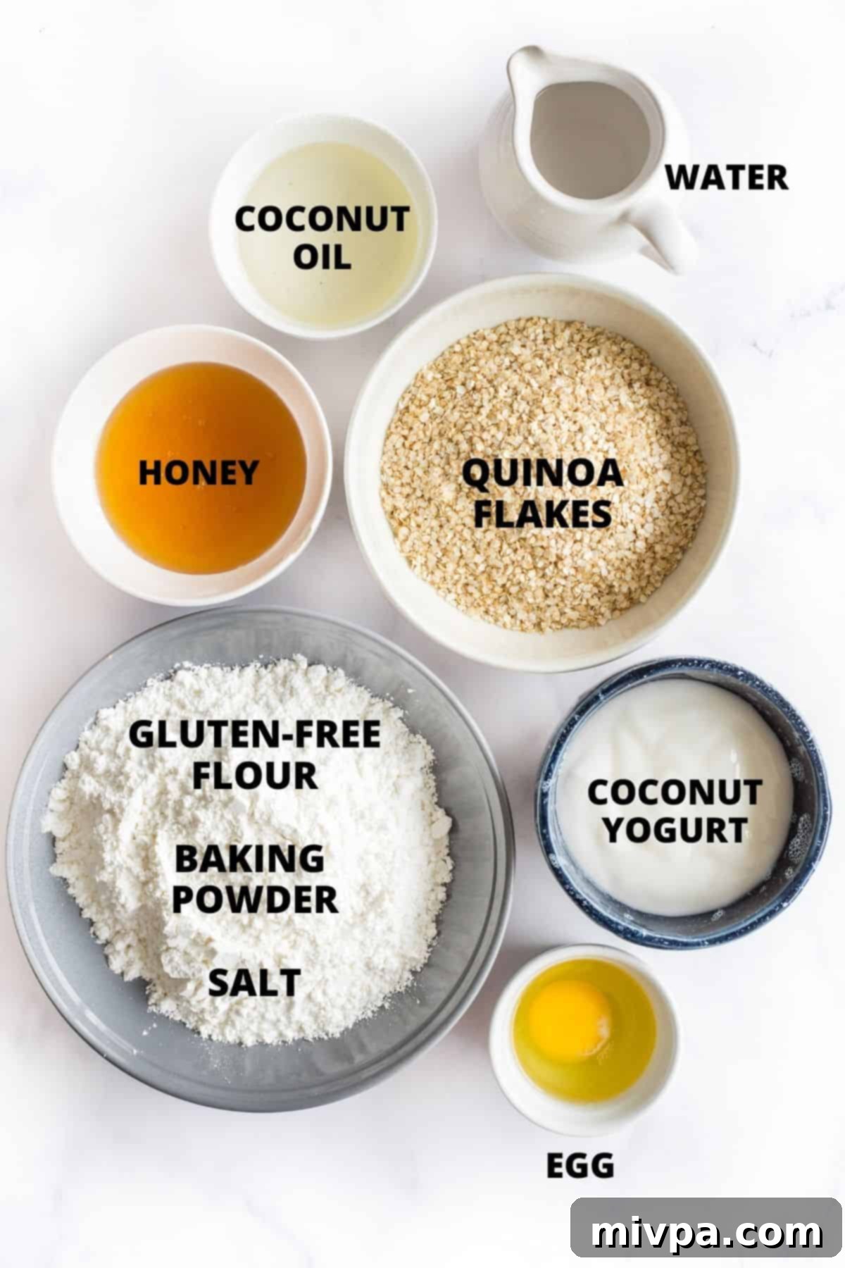 Ingredients for honey quinoa bread laid out on a marble board.
