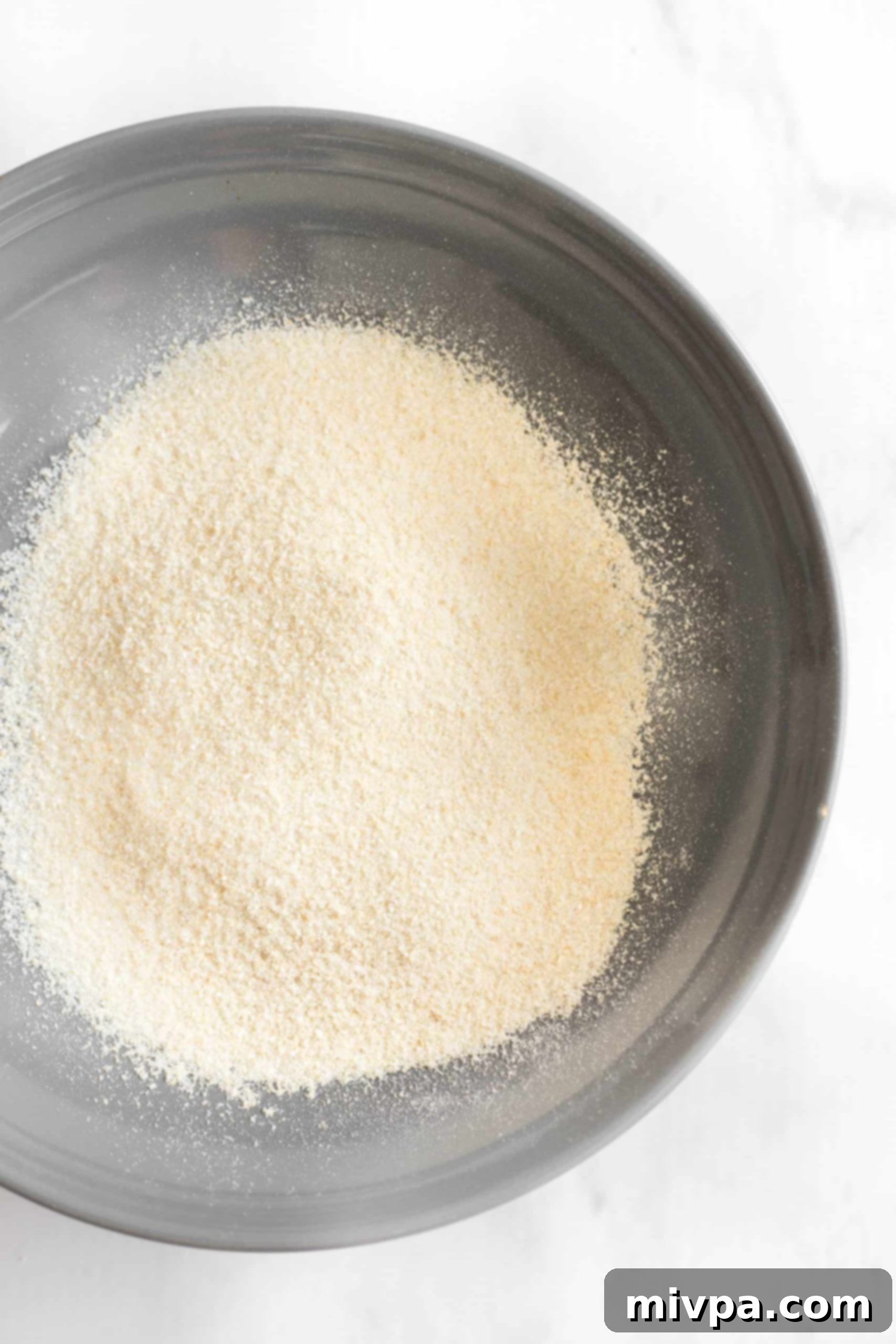 A bowl filled with finely ground brown rice flour, signifying completion of the milling process.
