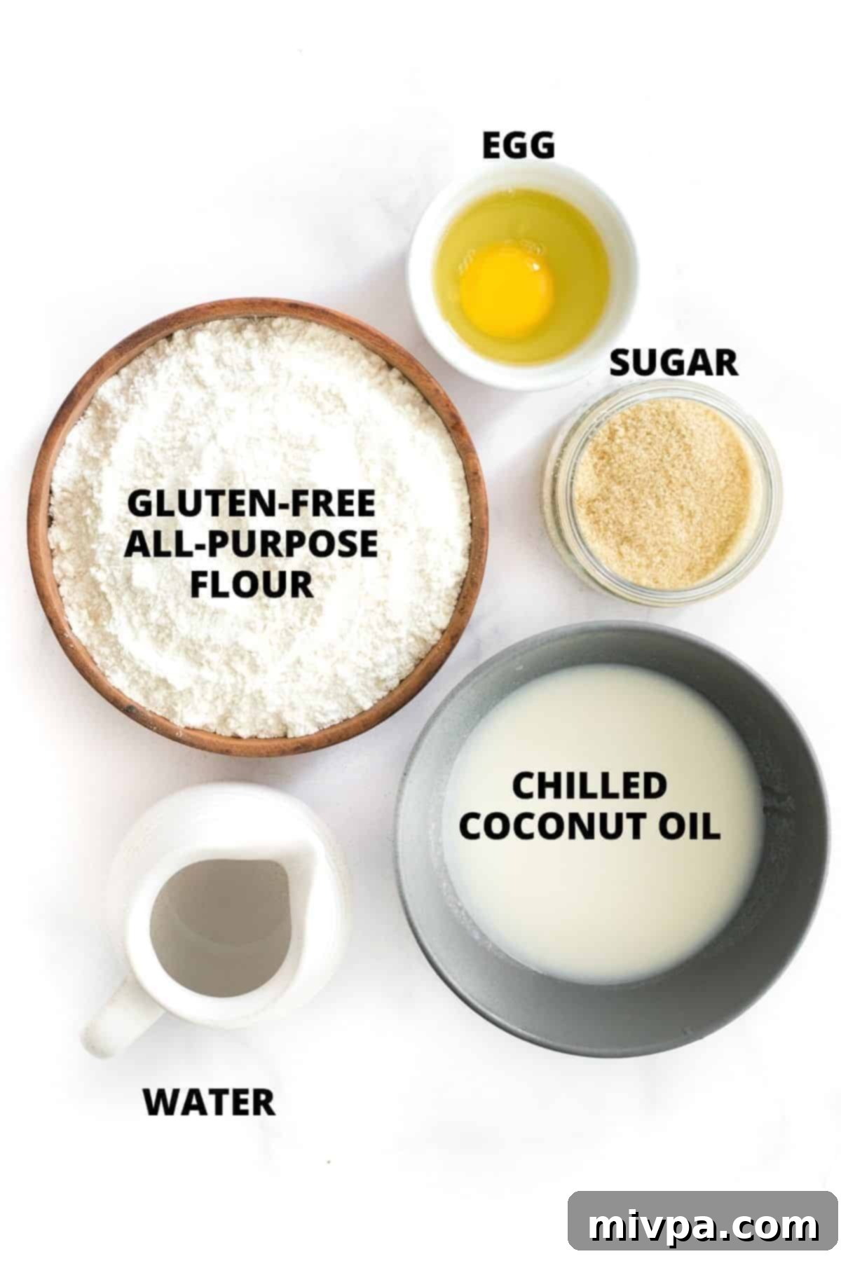 Top down view of ingredients for gluten-free pie crust laid out on marble board.