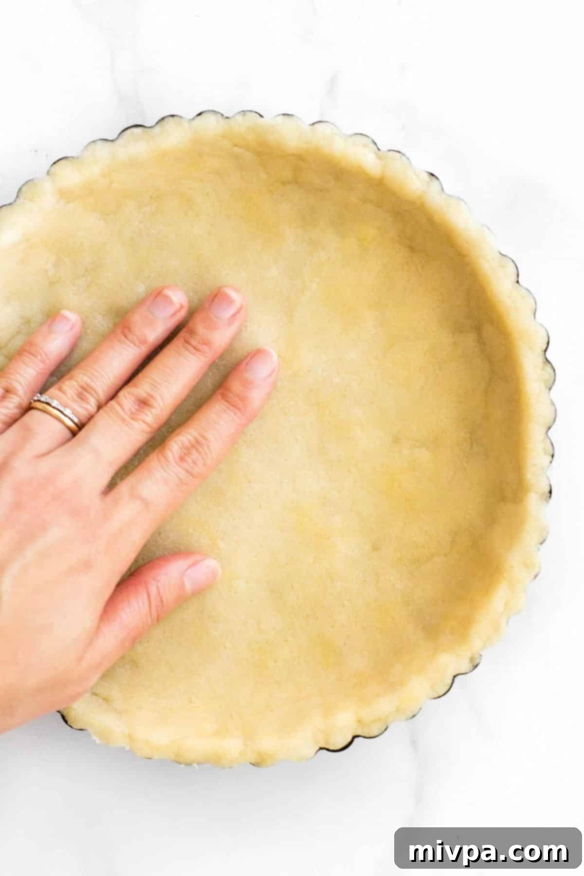 Pressing gf pie dough into pie pan.